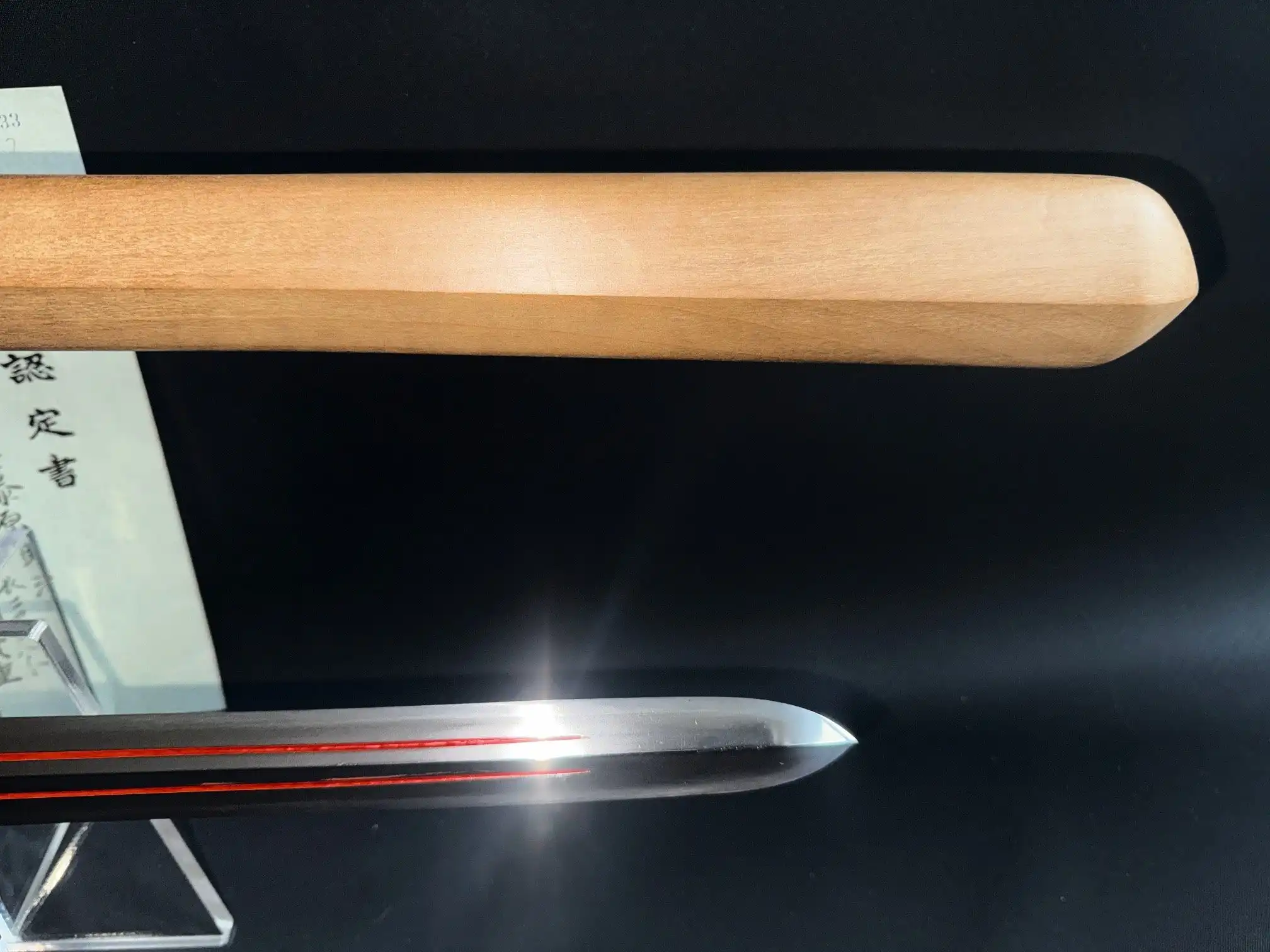 Close-up Ōmi Yari Sukekiyo Naginata blade with red grooves and wooden handle, Kyodai Originals
