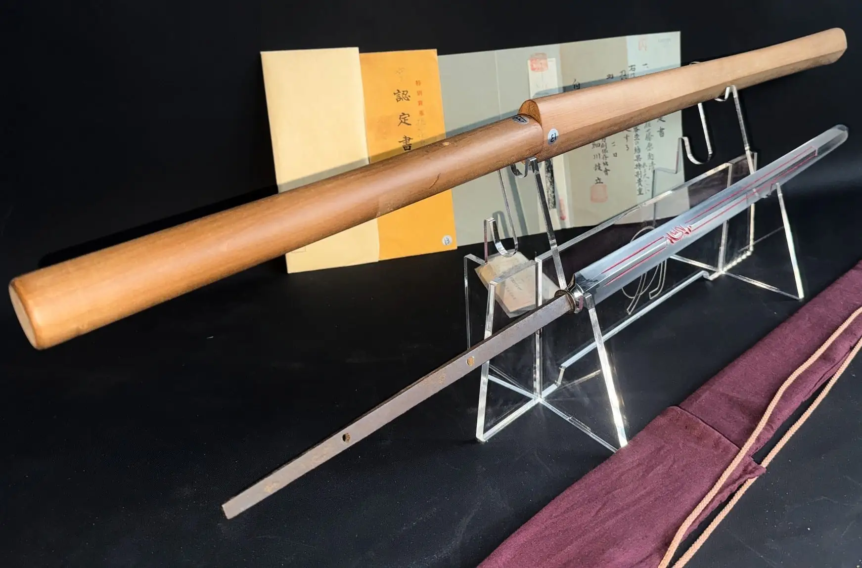 Omi Yari Sukekiyo yari / naginata with wooden sheath and clear blade displayed on stands