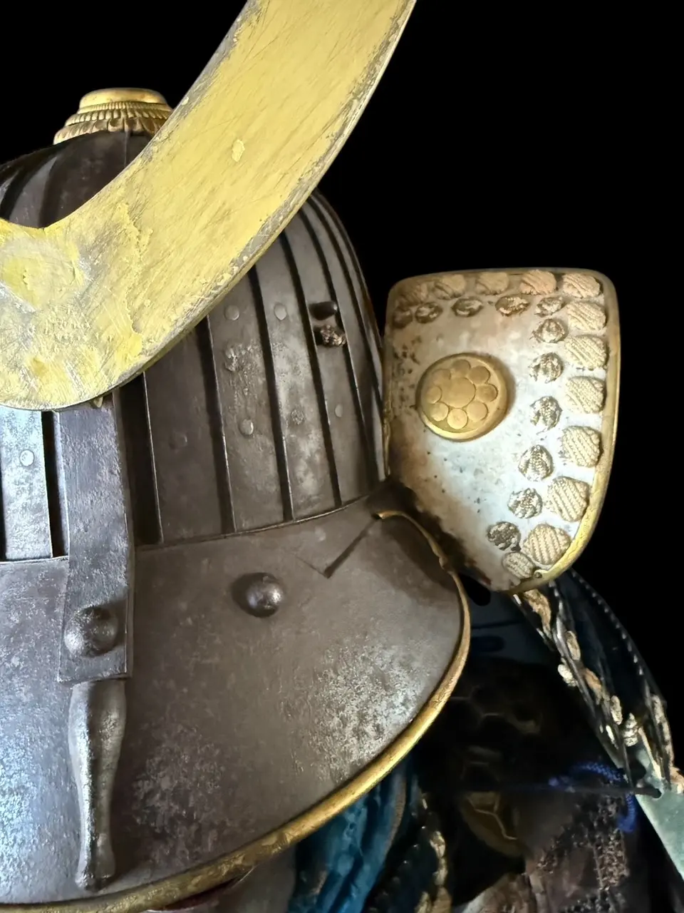 Close-up of Edo Period Mogami Dou Gusoku samurai armor showing helmet and Hosokawa clan crest detail