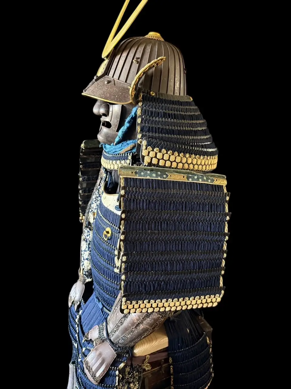 Left profile of Edo-Period Samurai Armor, Mogami Dou Gusoku, with iron black lacquer and blue lacing.
