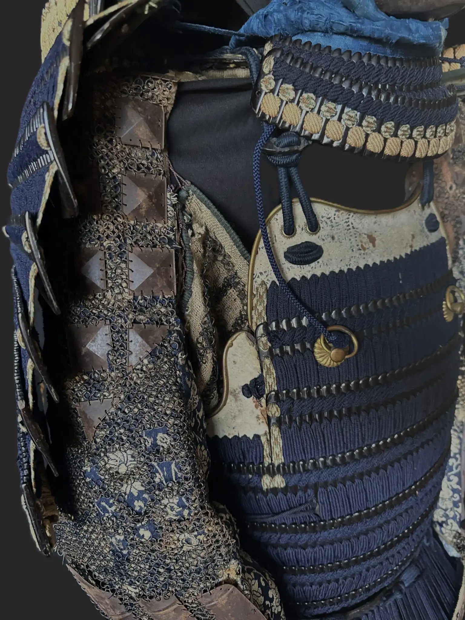 Close-up of a blue Mogami Dou Gusoku Armor with intricately woven patterns and black lacquer plating
