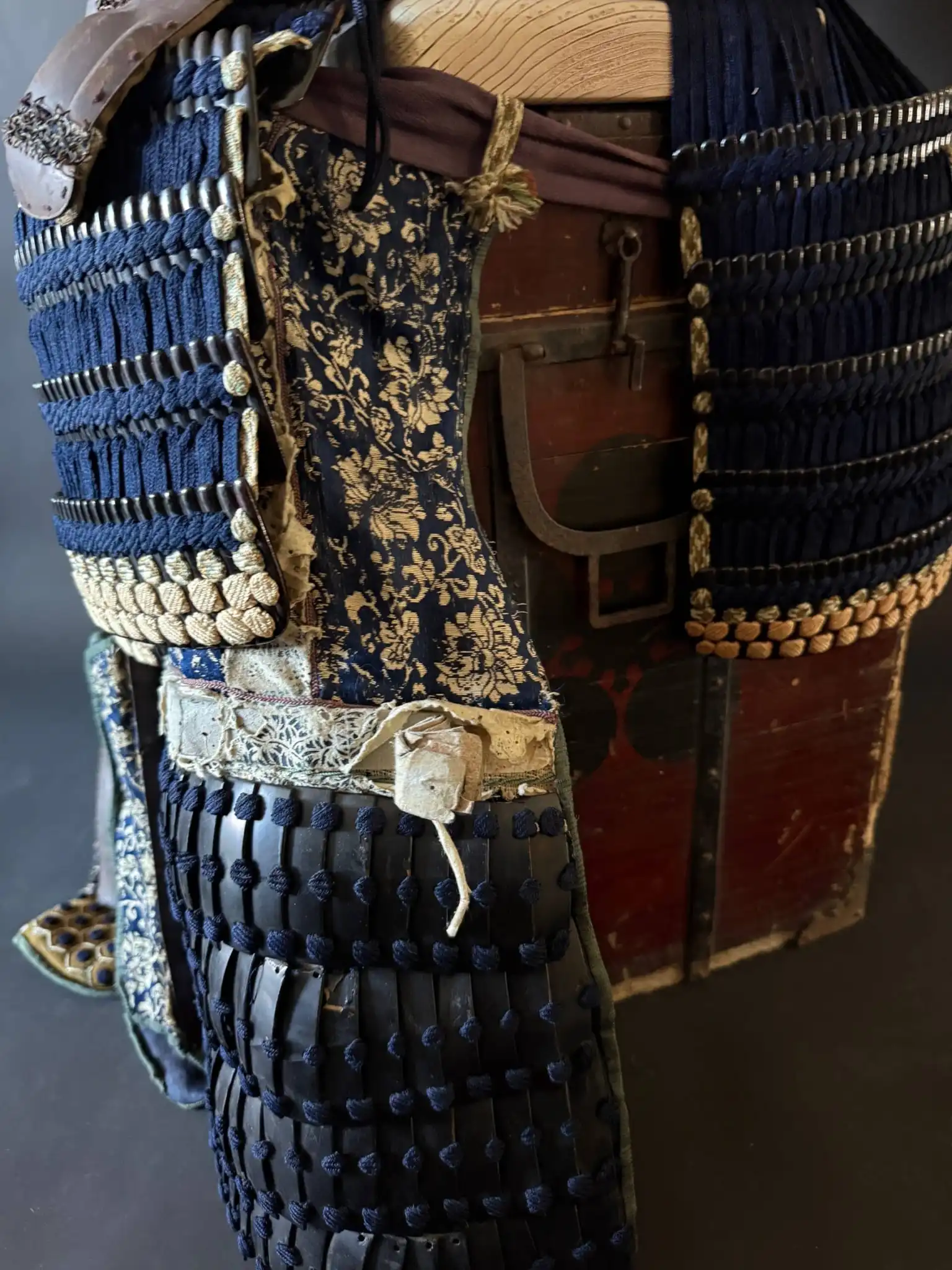 Close-up of a Mogami Dou Gusoku Armor, an Edo-period Samurai Armor, showing black lacquer plates & blue lacing detail