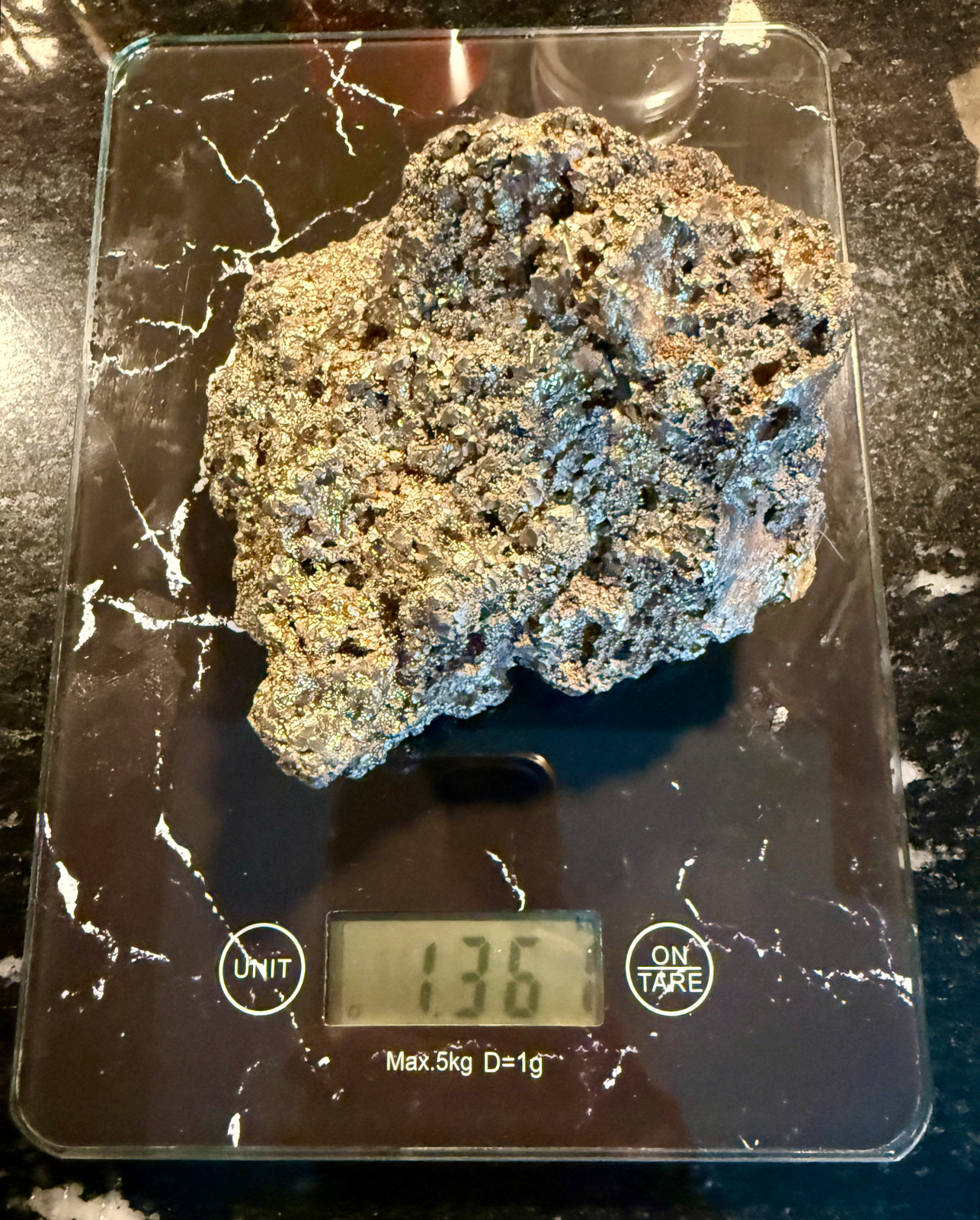 Shiny Japanese Tamahagane Steel accessories on a digital scale showing 1.36kg from an overhead view