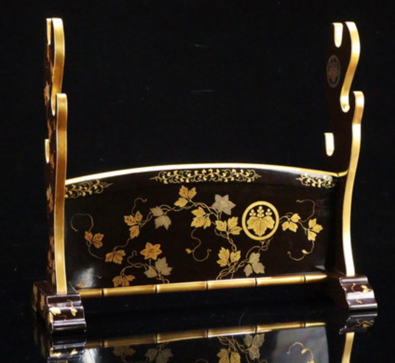 Antique Japanese Three-Sword Kake with gold maki-e paulownia mon on black lacquer katana stand facing right