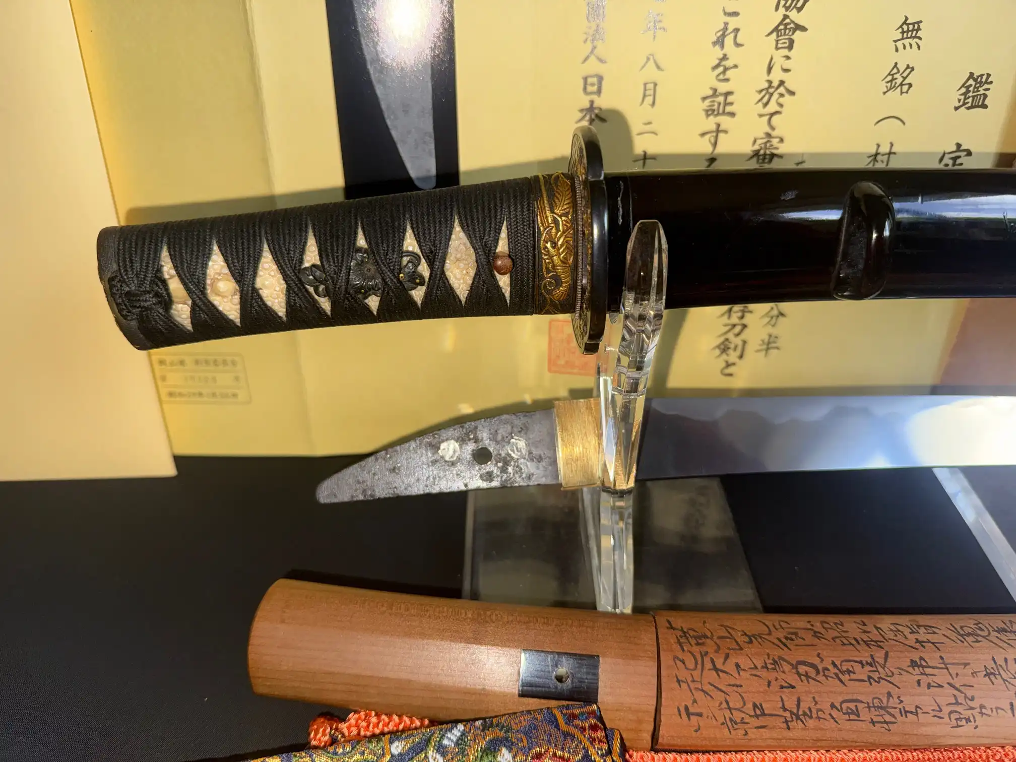Nidai Muramasa Sayagaki Katana, close-up of handle and partial blade with antique Japanese document