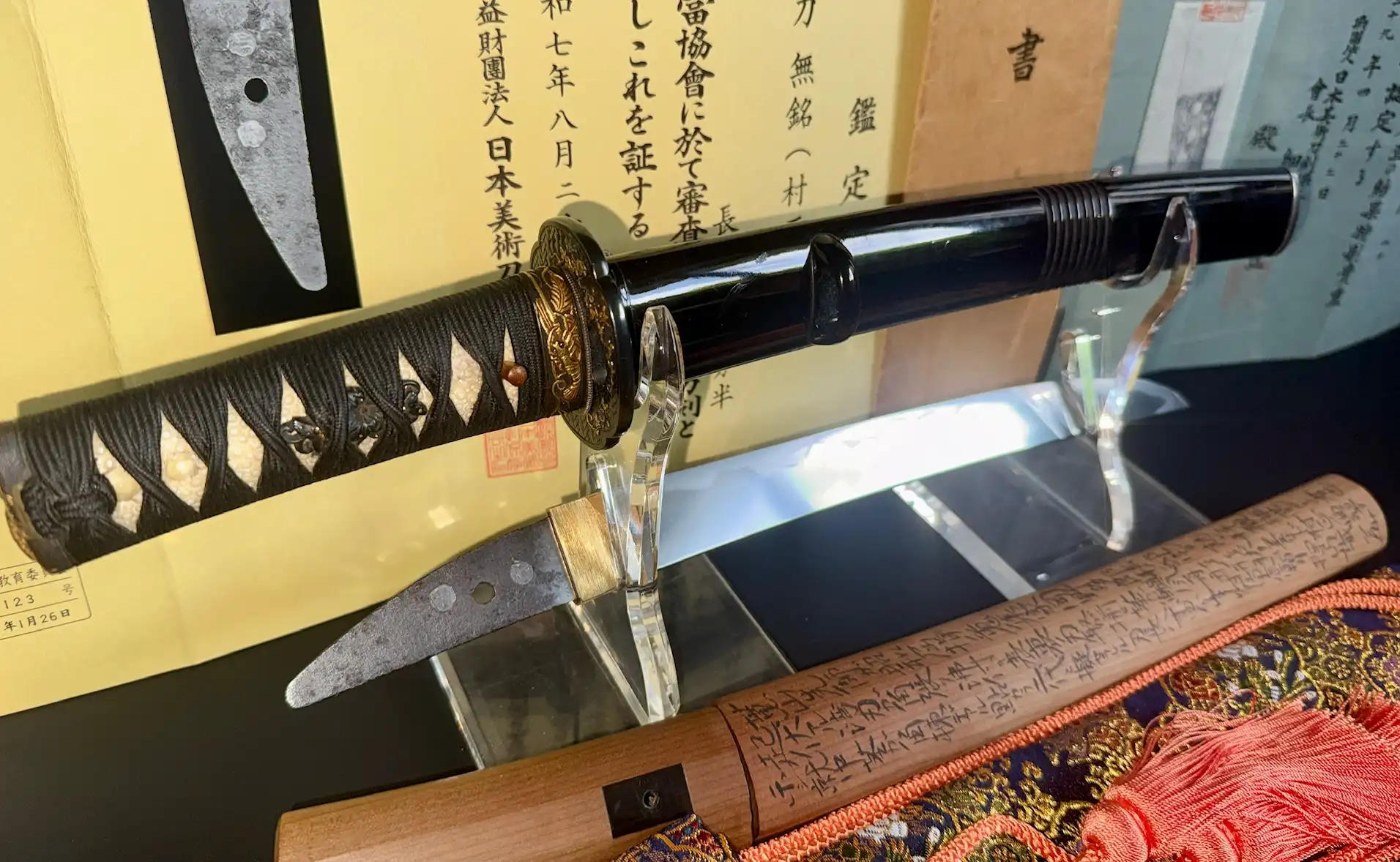 Close-up of a Nidai Muramasa Katana, Sayagaki by Tanobe Sensei visible with authentication papers.