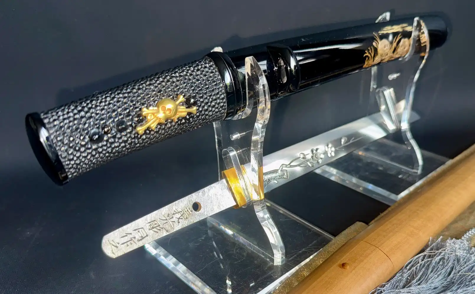Ono Yoshimitsu Mukansa Tanto Masterpiece, black braided handle with gold skull, blade with cherry blossom inlay