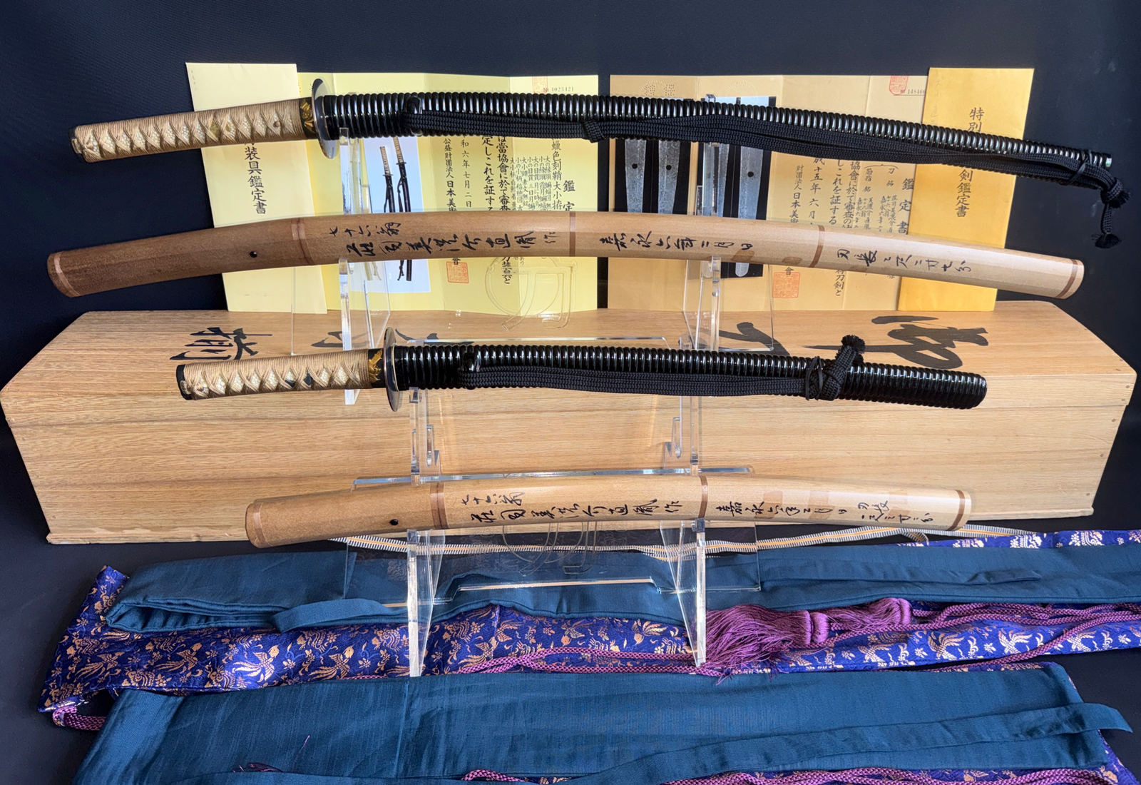 Naotane’s Final Known Daishō katana pair with wooden sheaths and intricate hilt wraps on display