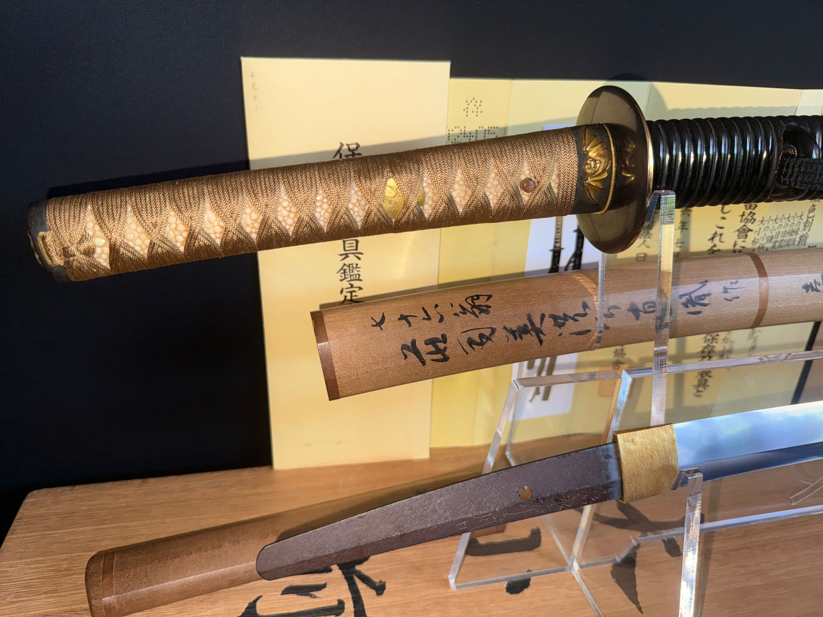 Naotane's Final Known Daishō katana with detailed handle and partial blade, certificate visible