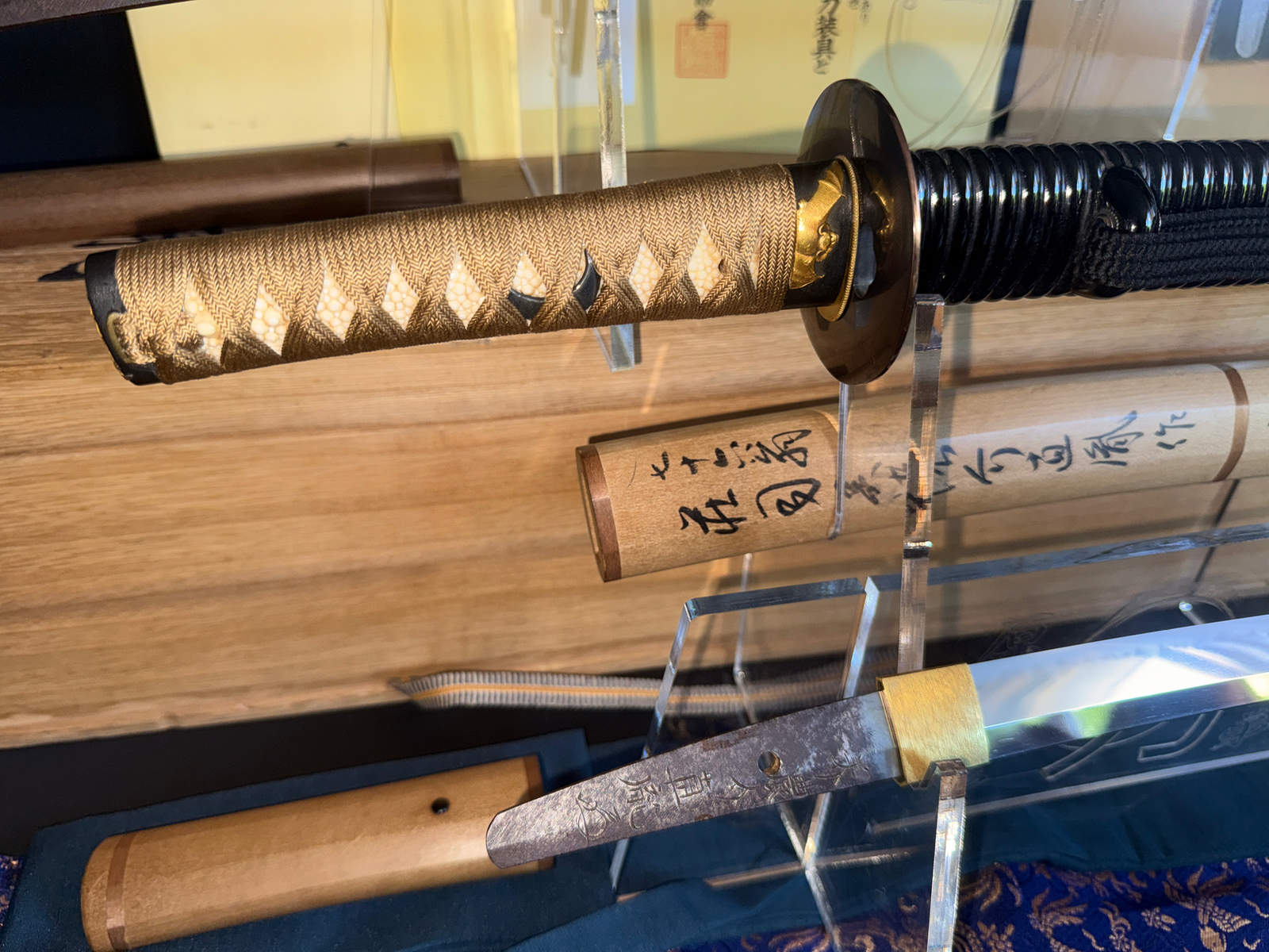 Close-up of Naotane's Final Known Daishō katana hilt and exposed tang with inscription, blade in foreground