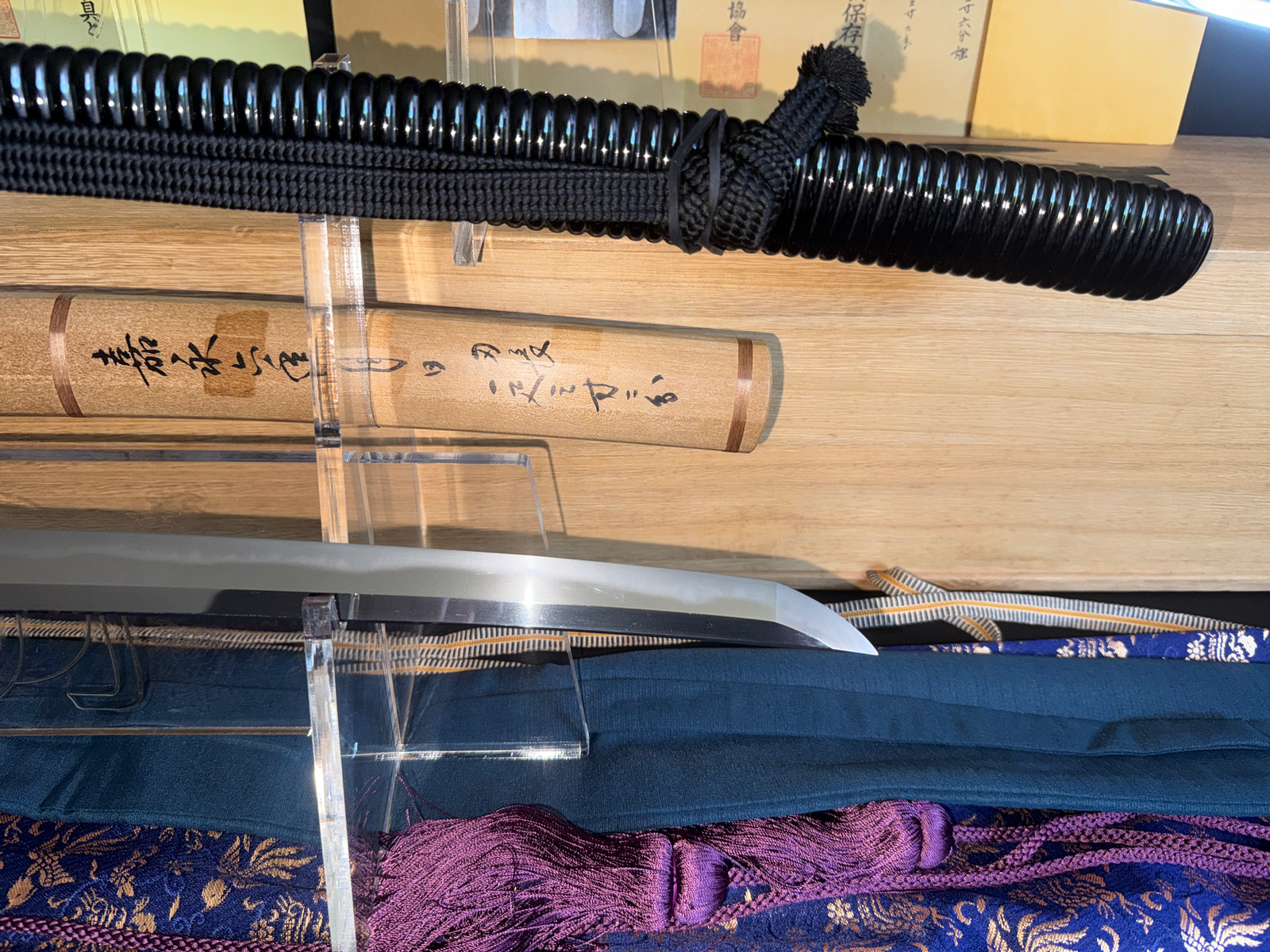 Naotane's Final Known Daishō katana with its saya and blade, seen from above, on a stand
