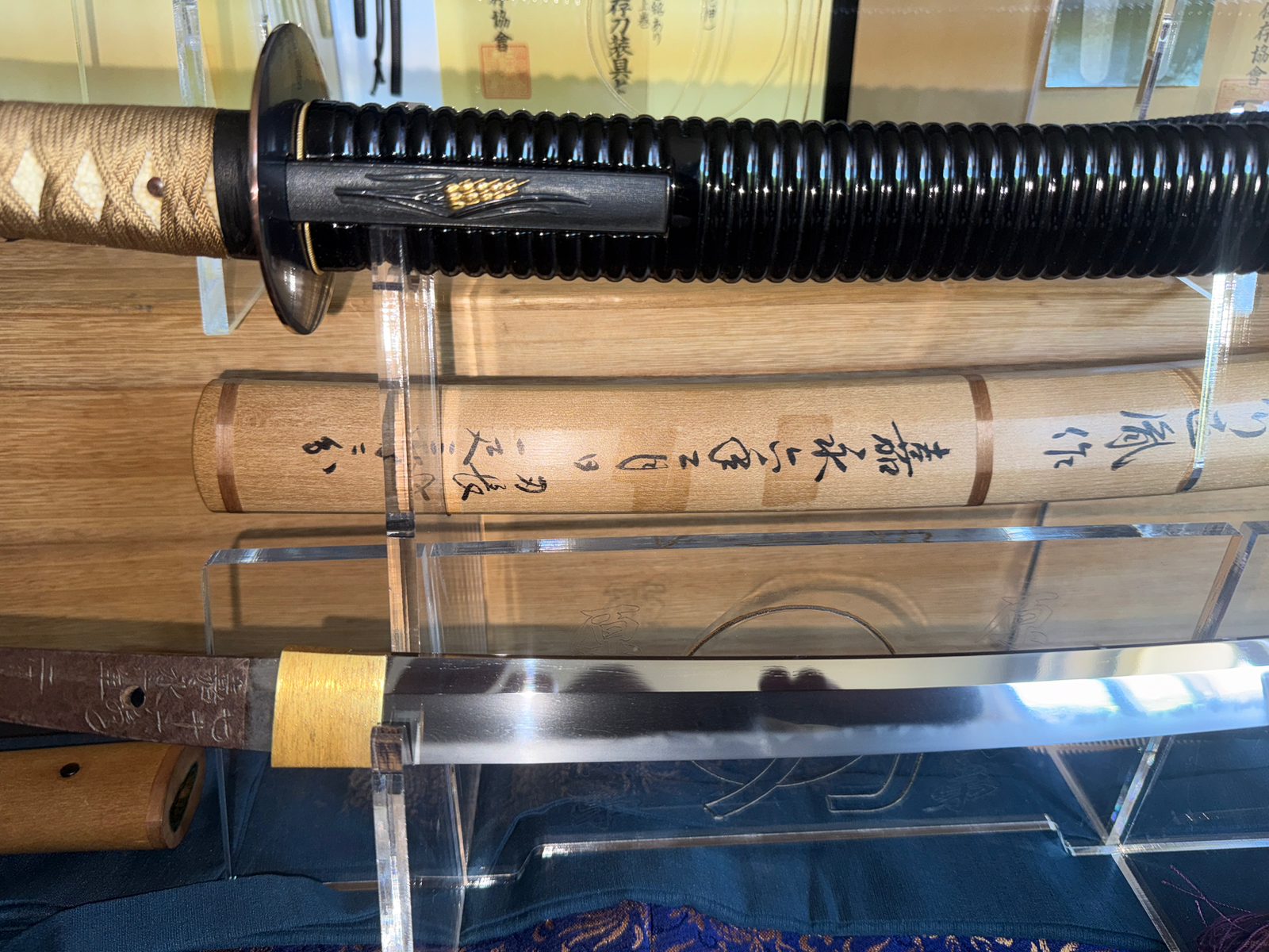 Naotane's Final Known Daishō katana with its saya and blade visible, displayed on a wooden surface