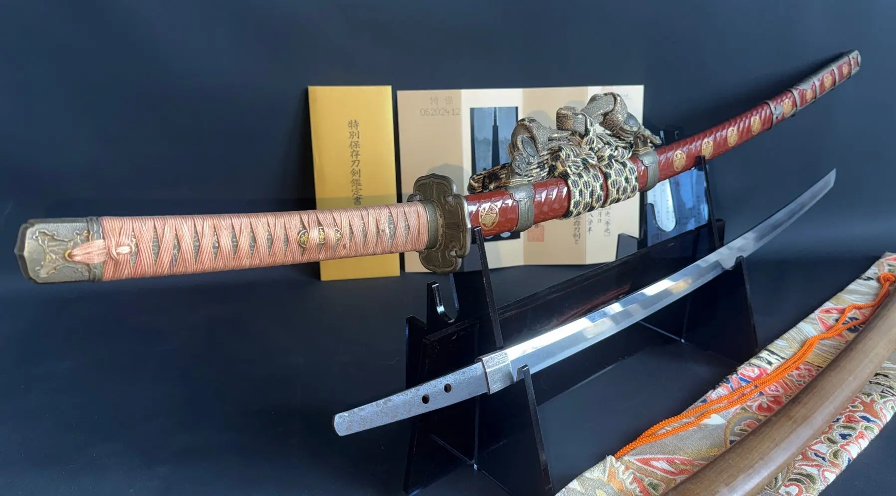 Elegant Nanbokuchō Tachi Hidemitsu katana with intricate red saya and wrapped tsuka on display
