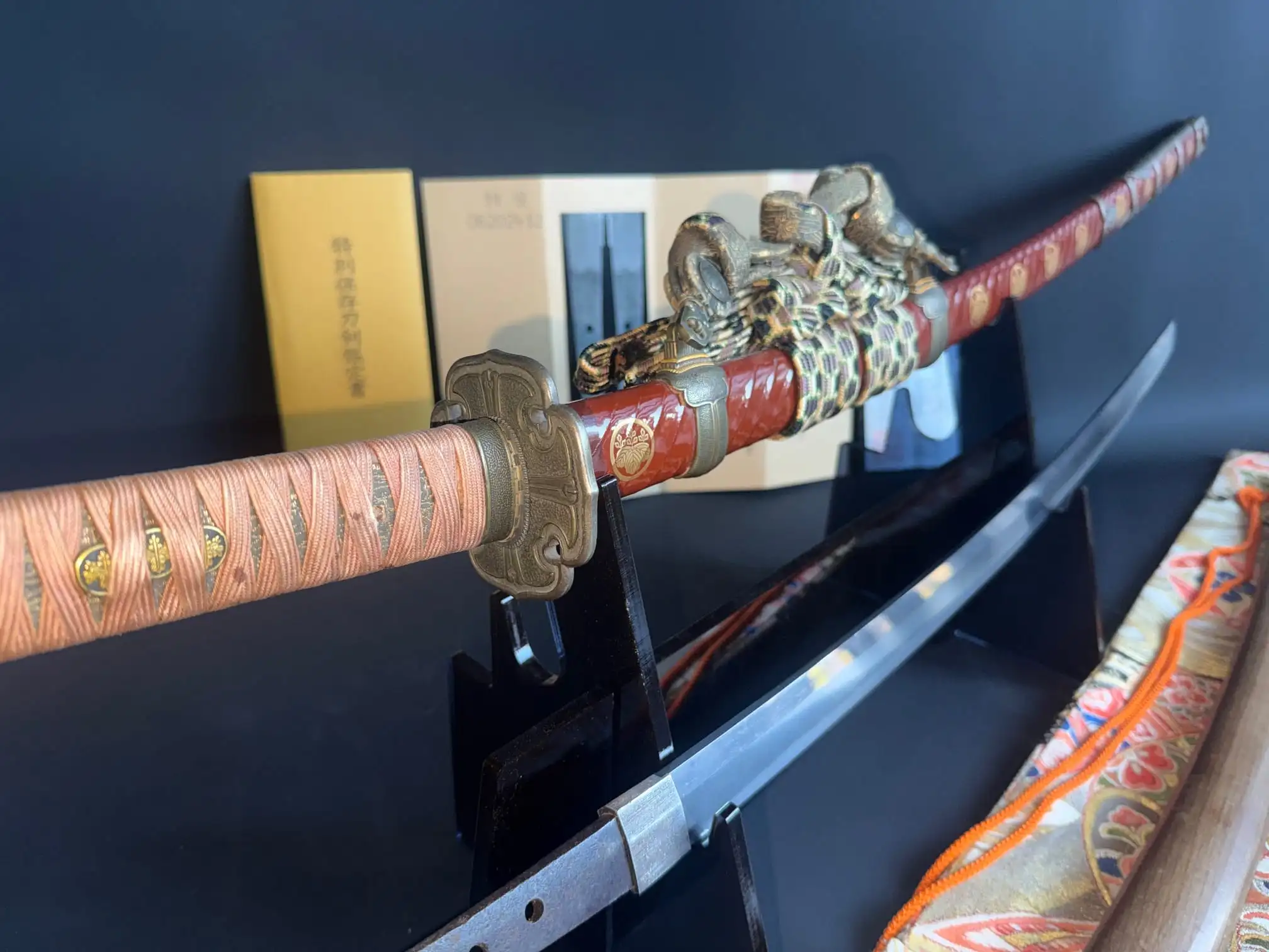 Nanbokuchō Tachi Hidemitsu katana on stand with detailed handle and visible blade, with shirasaya