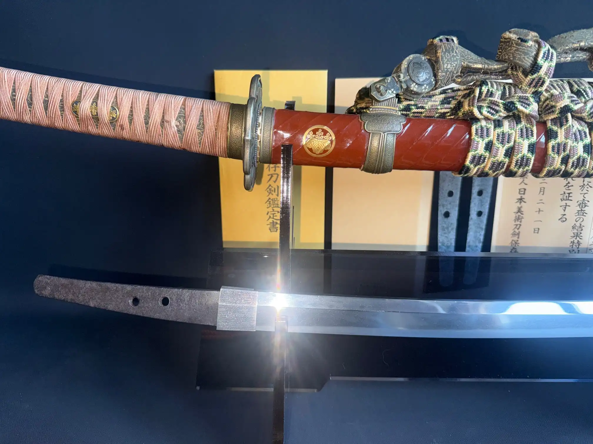 Nanbokuchō Tachi Hidemitsu katana, close-up of a partially sheathed blade and ornate tsuka