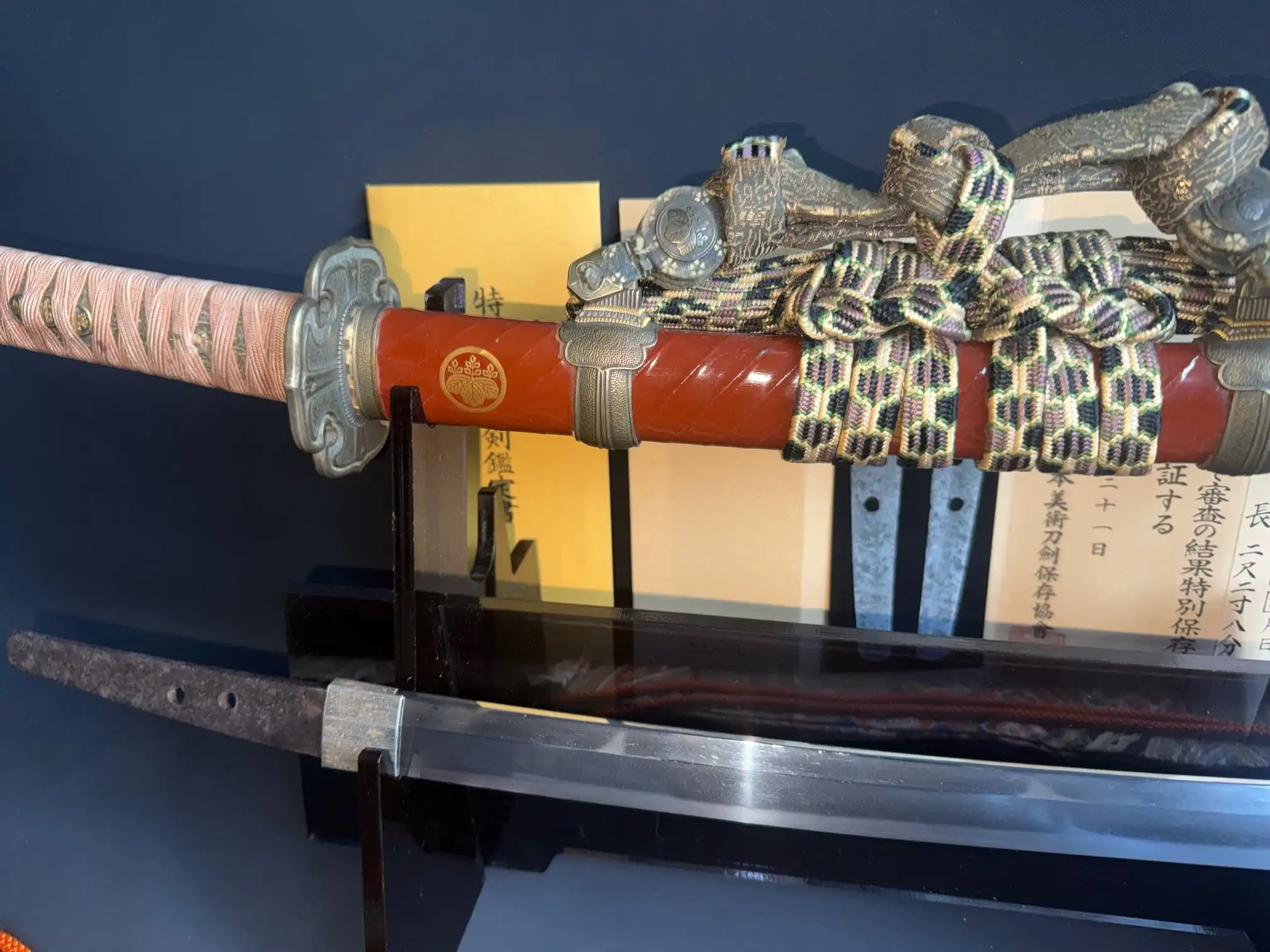 Nanbokuchō Tachi Hidemitsu Katana with red lacquered saya and intricate braided tsuka on display