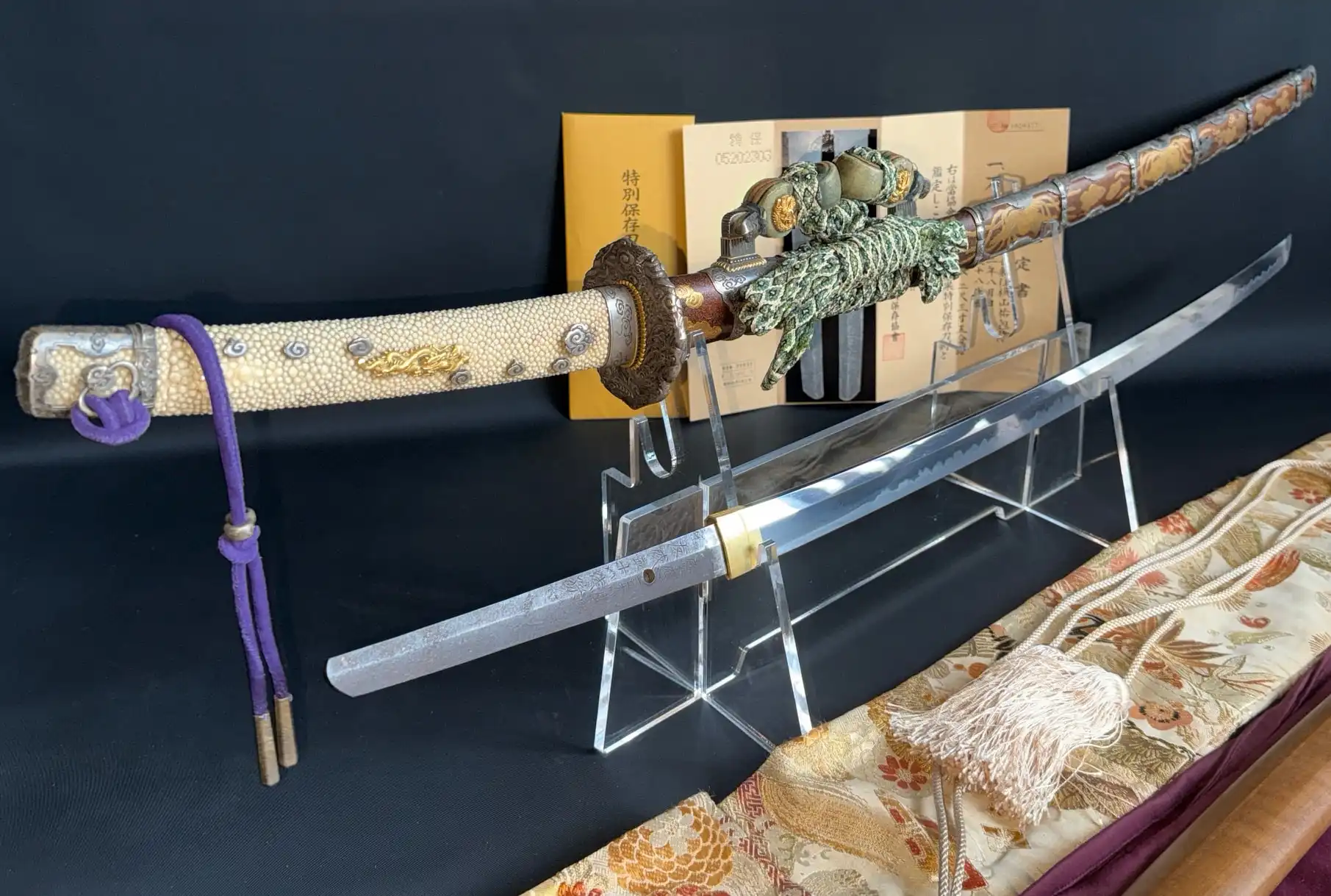 Tachi Yokoyama Sukekane katana, ornate scabbard and hilt with detached blade, on display stands