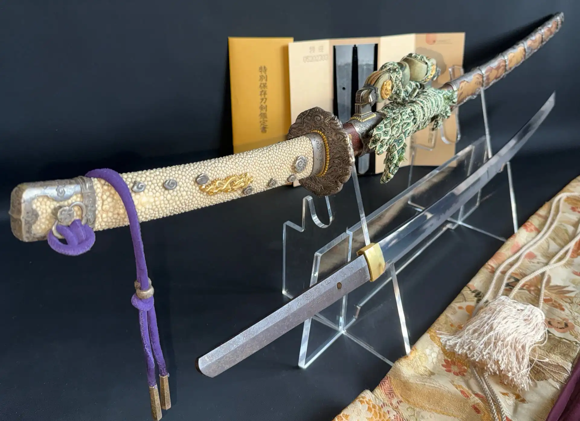 Tachi Yokoyama Sukekane Katana, full view, with ornate hilt and blade displayed in foreground, with documents
