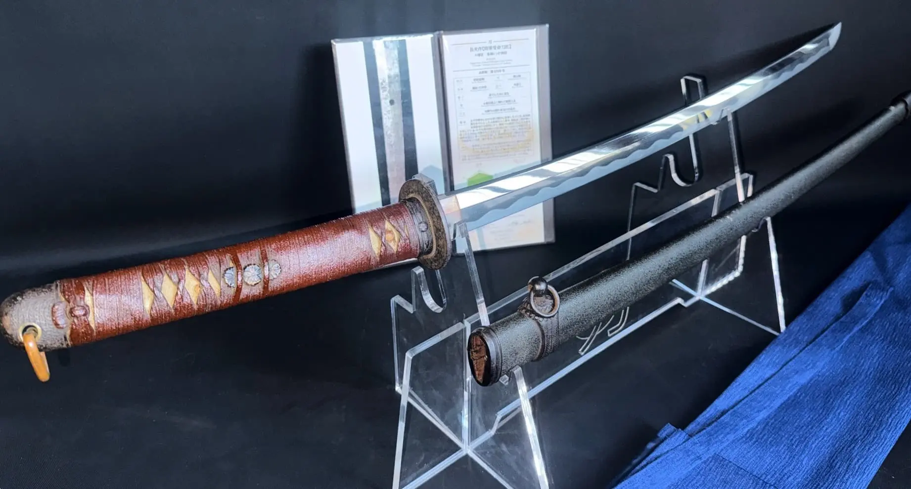 WWII Katana Ichihara Nagamitsu with fine hamon, full tang, and scabbard on display with papers