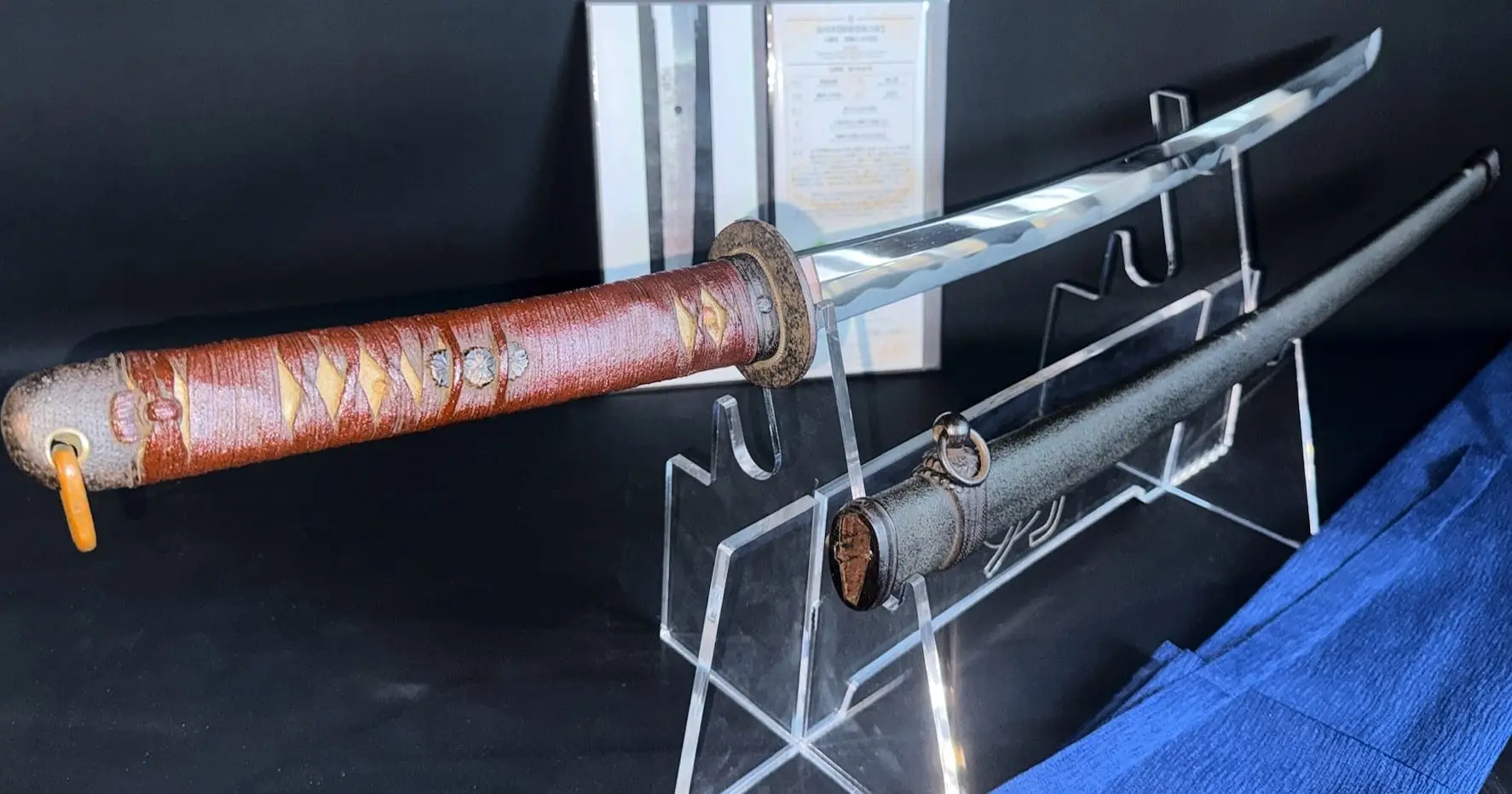 WWII Katana Ichihara Nagamitsu displayed with scabbard, showing the saya and the red wrapped tsuka