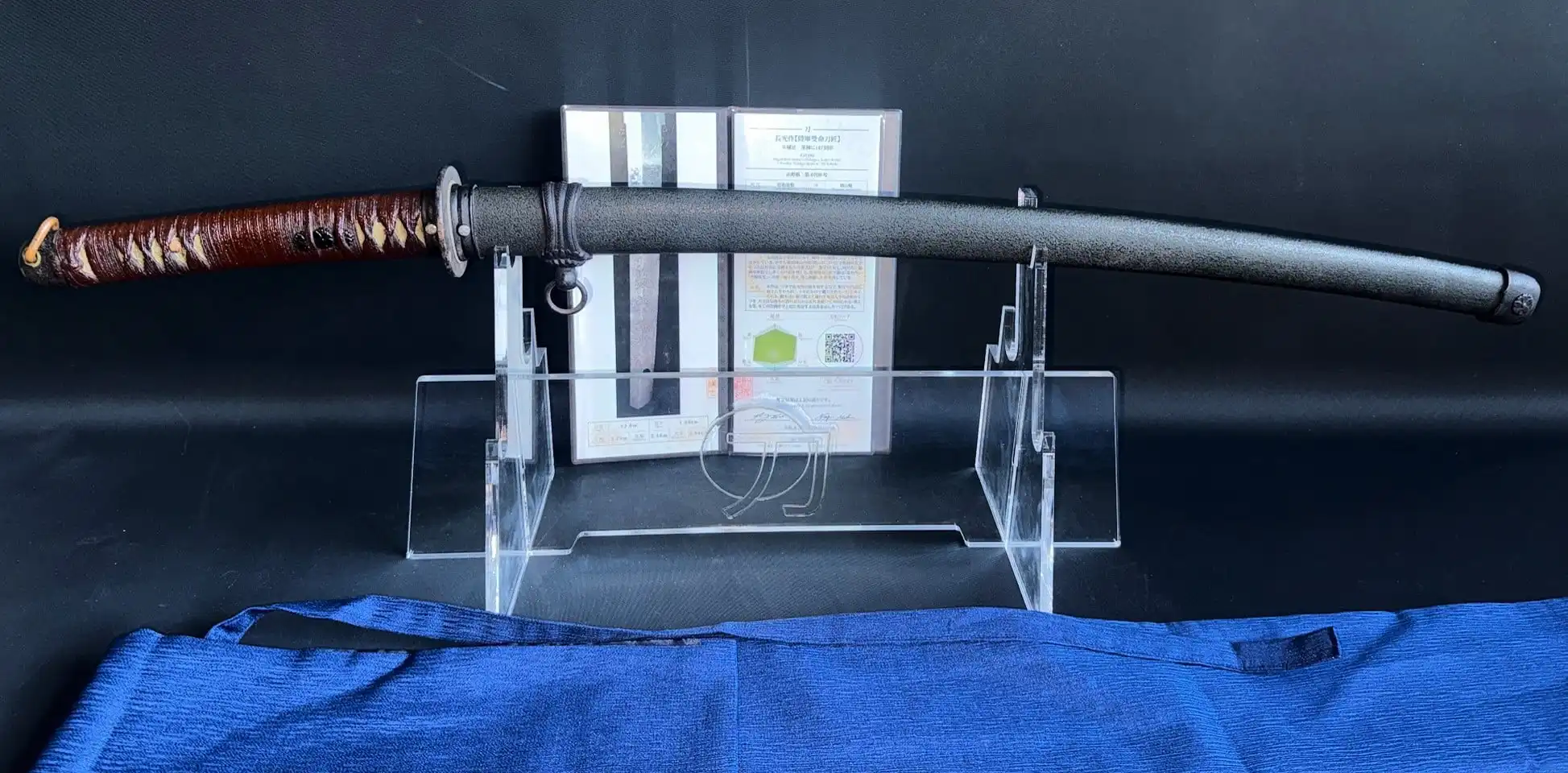 WWII Katana Ichihara Nagamitsu on stand, showing brown tsuka handle and dark saya scabbard, top-down view