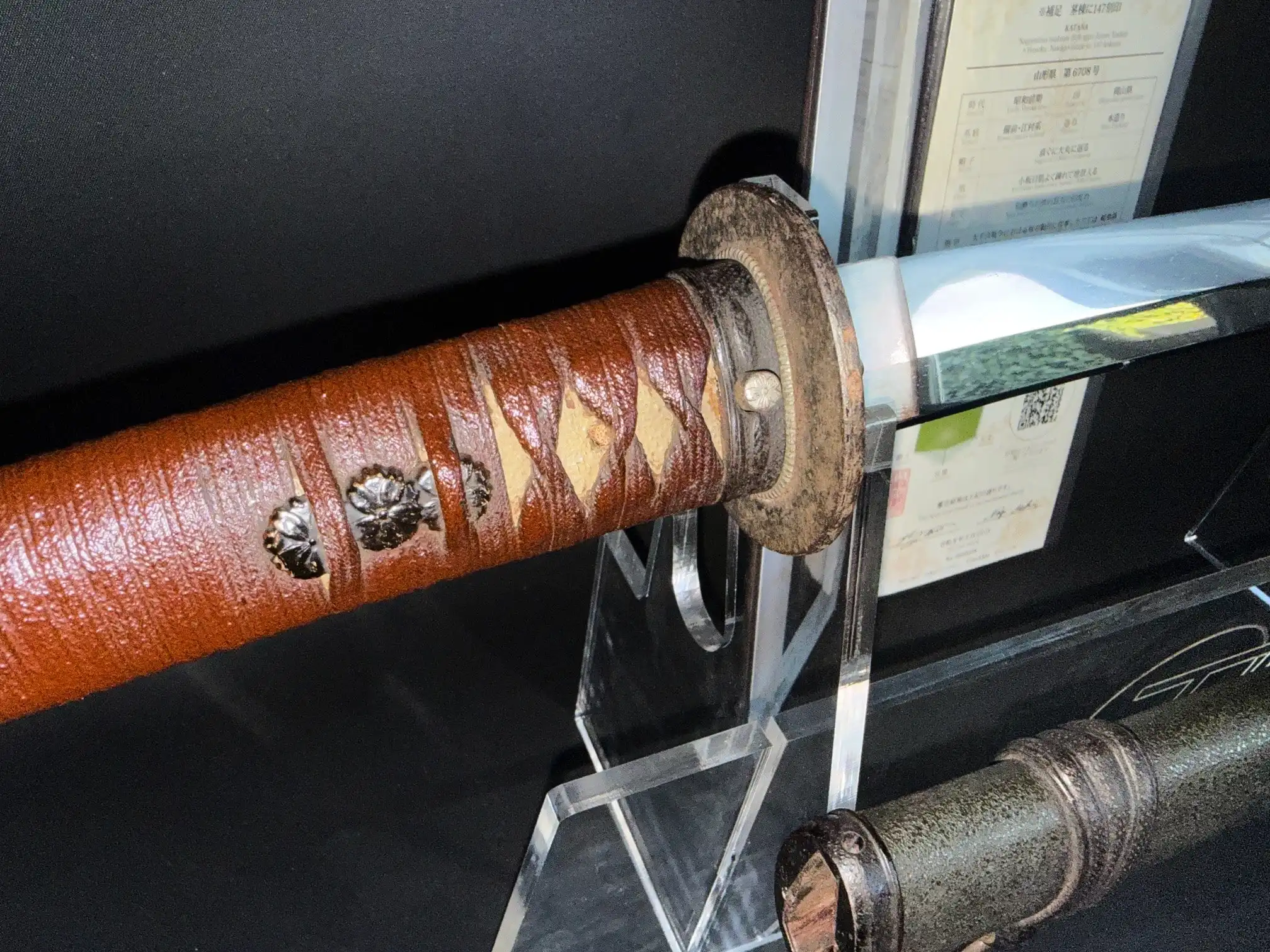 Close-up of a WWII Katana Ichihara Nagamitsu hilt and tsuba with a sharp blade visible in 1943 Katana.