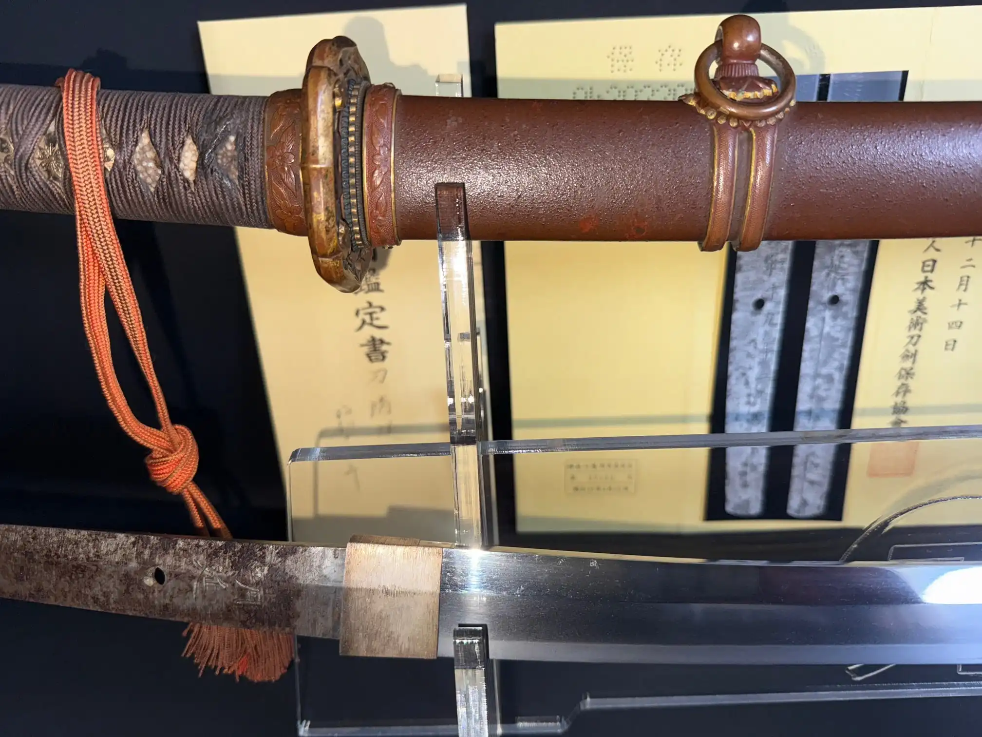 Close-up of a Yasukuni Gendaitō Yasunobu katana, showing detailed Type 98 mounts and shiny blade.