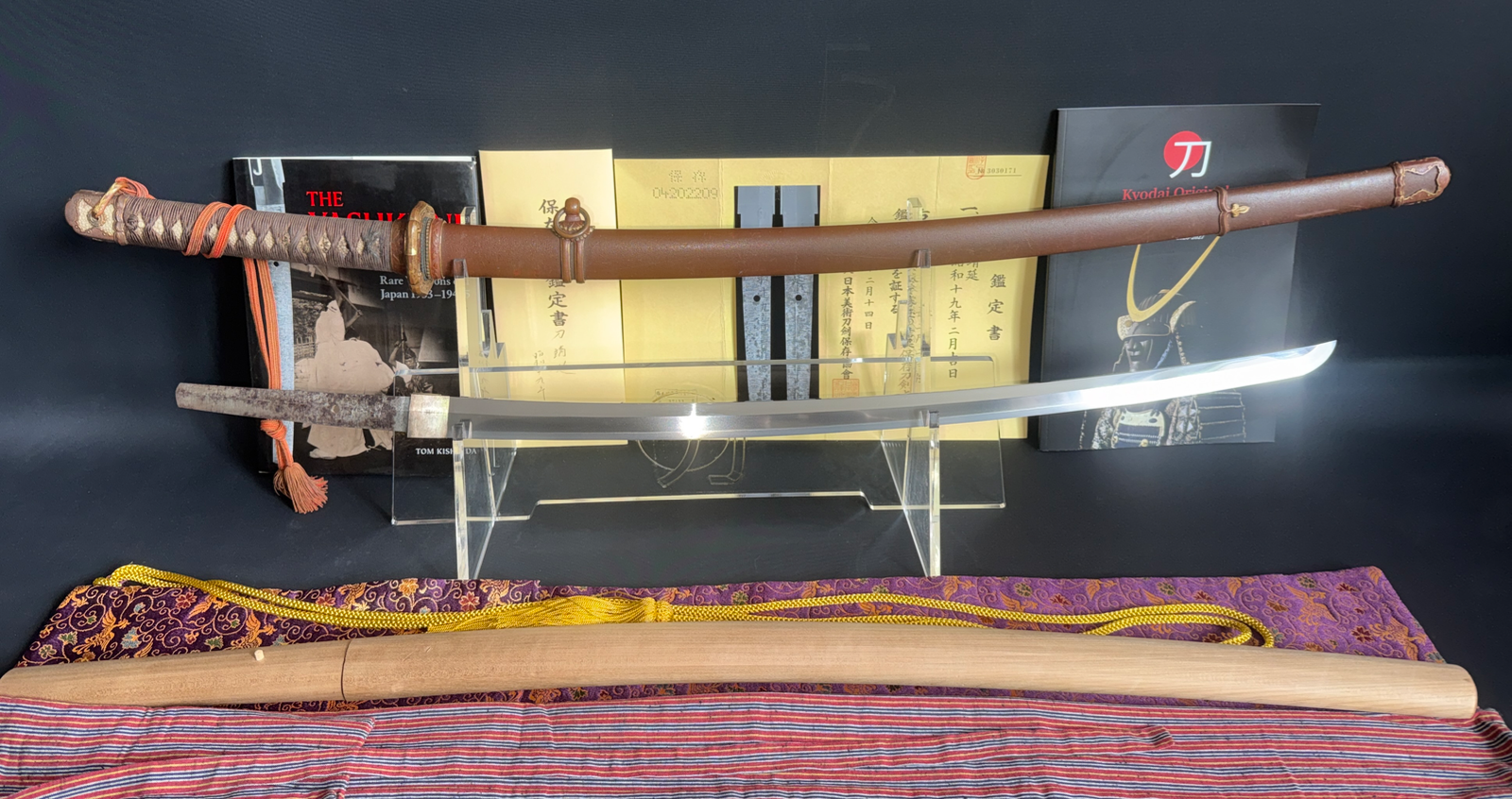 Full view of a Yasukuni Gendaitō Yasunobu katana, mounted and unmounted blades, and accompanying documents