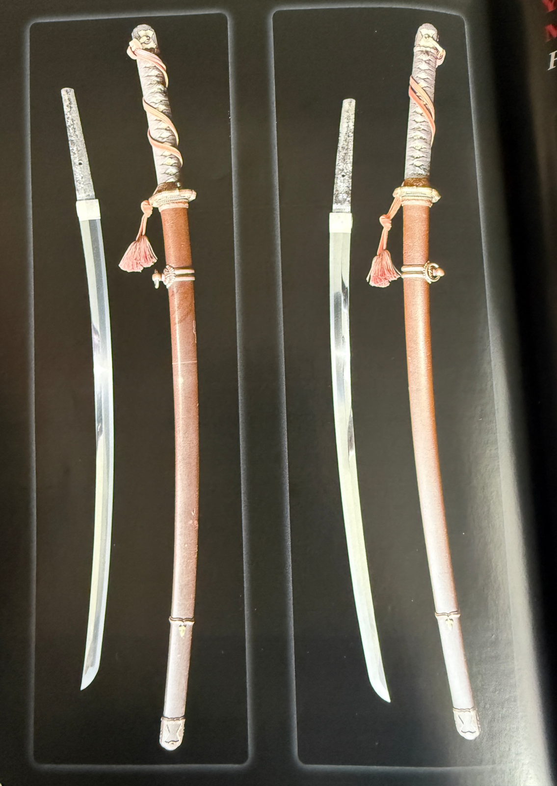Side view of two Kyodai Originals Yasukuni Gendaitō Yasunobu katana with scabbards and exposed blades