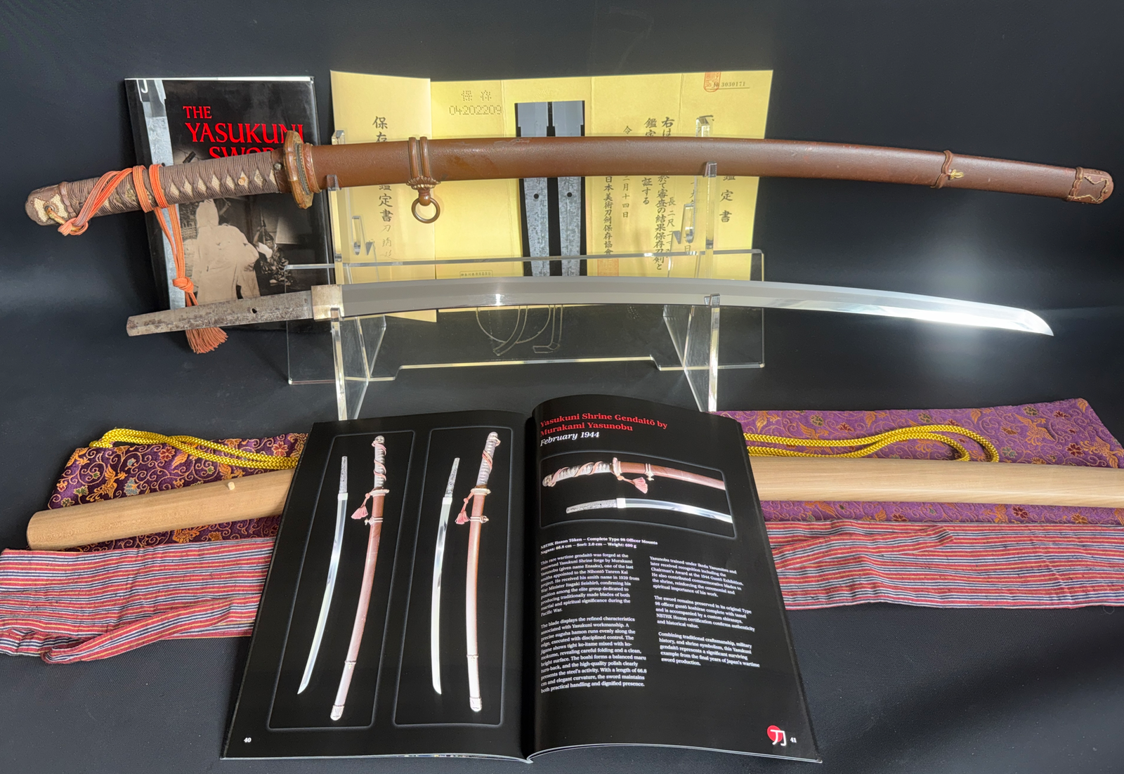A Kyodai Originals Yasukuni Gendaitō Yasunobu katana, full view with mounts and book.