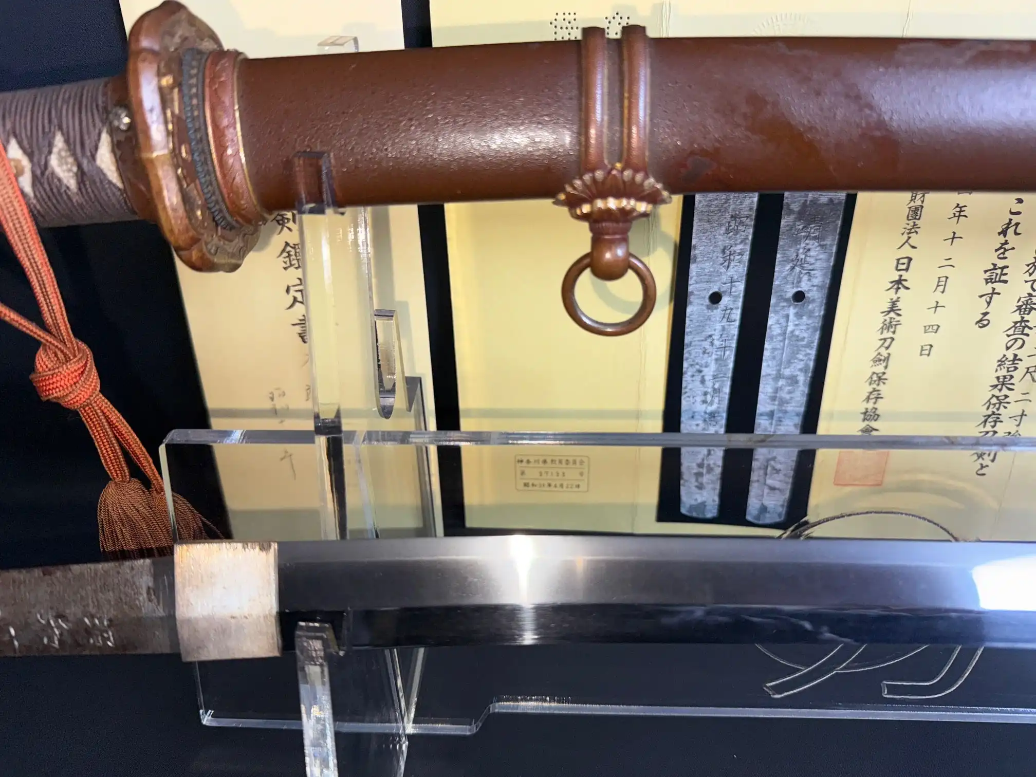 Close-up of a Yasukuni Gendaitō Yasunobu katana, showing detailed Type 98 mounts and shiny blade.