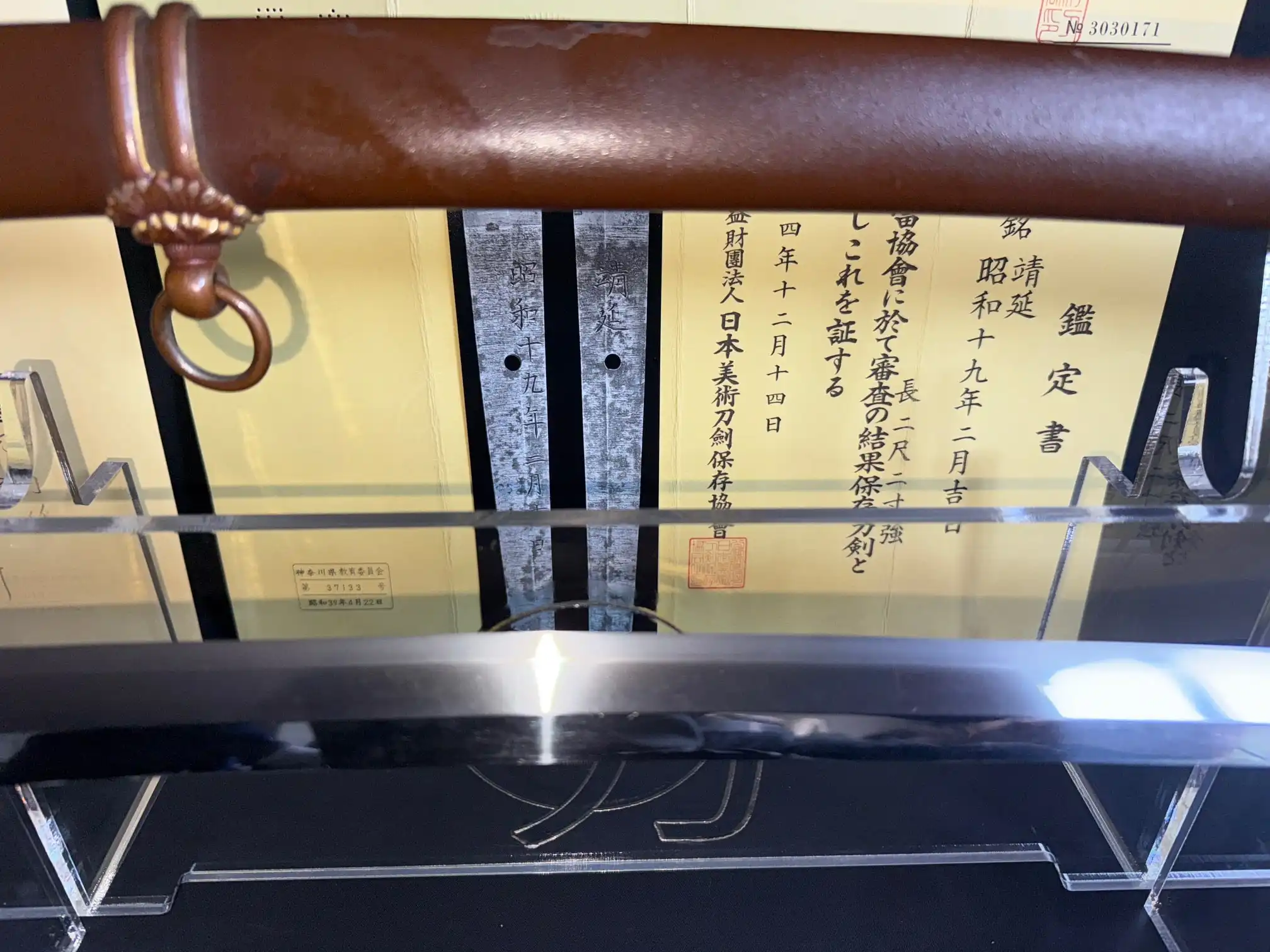 Katana Yasukuni Gendaitō Yasunobu with brown saya and paperwork, close-up of handle and blade