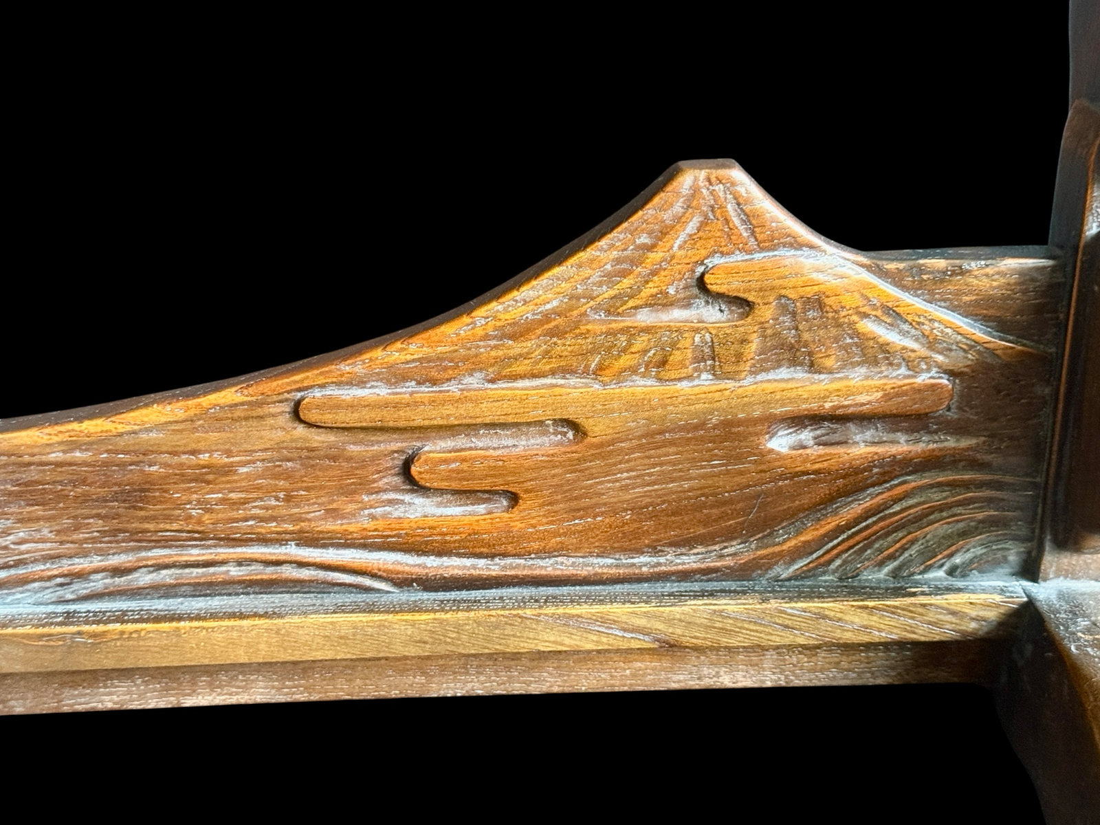 Close-up of Handcrafted Japanese Double Sword Stand Unkai Fuji Style, showing carved Mount Fuji and clouds, a katana stand kake.