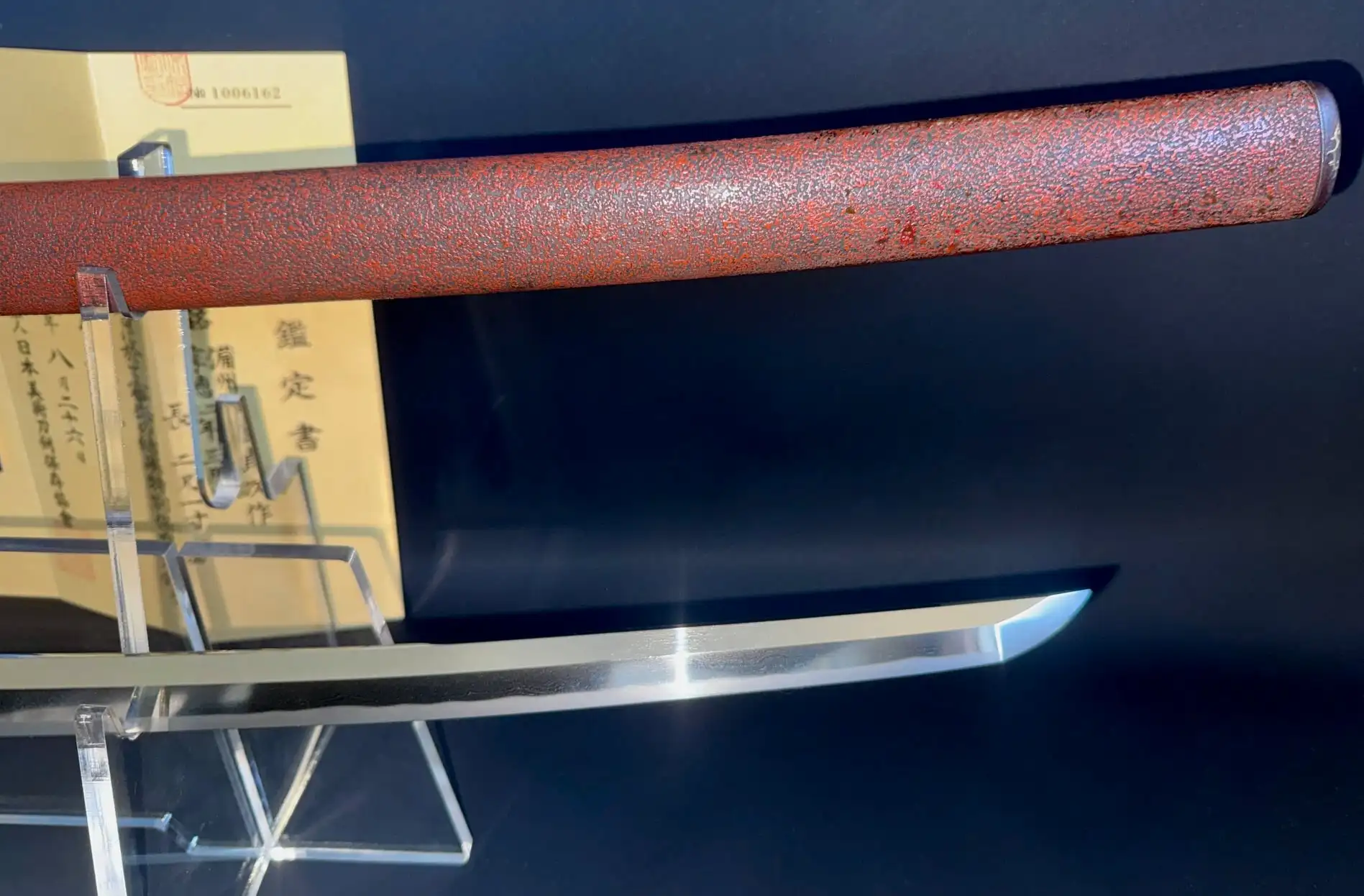 Blade and saya (scabbard) of Katana Bishū Tomo-jū Sadatsugu, shiny blade contrasts with red saya