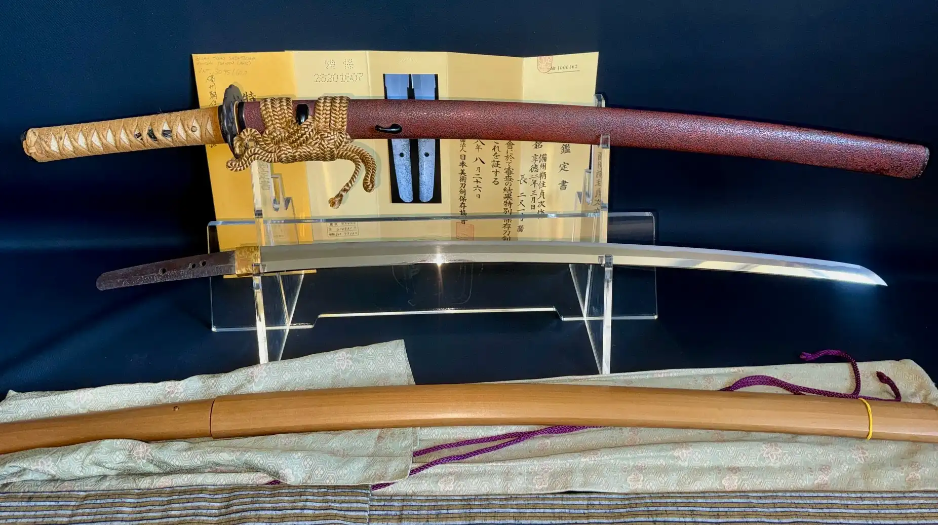 Katana Bishū Tomo-jū Sadatsugu, sword and koshirae top with blade below, on displays from Kyodai Originals