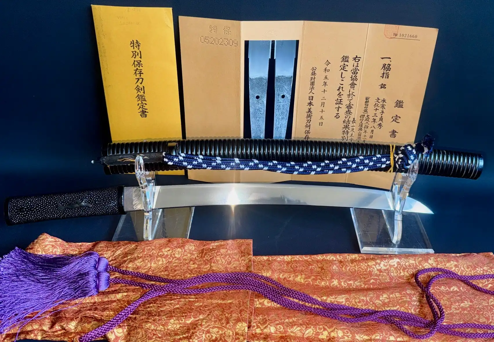 Suishinshi Masahide Wakizashi, blade on stand, with papers and purple silk, top-down view