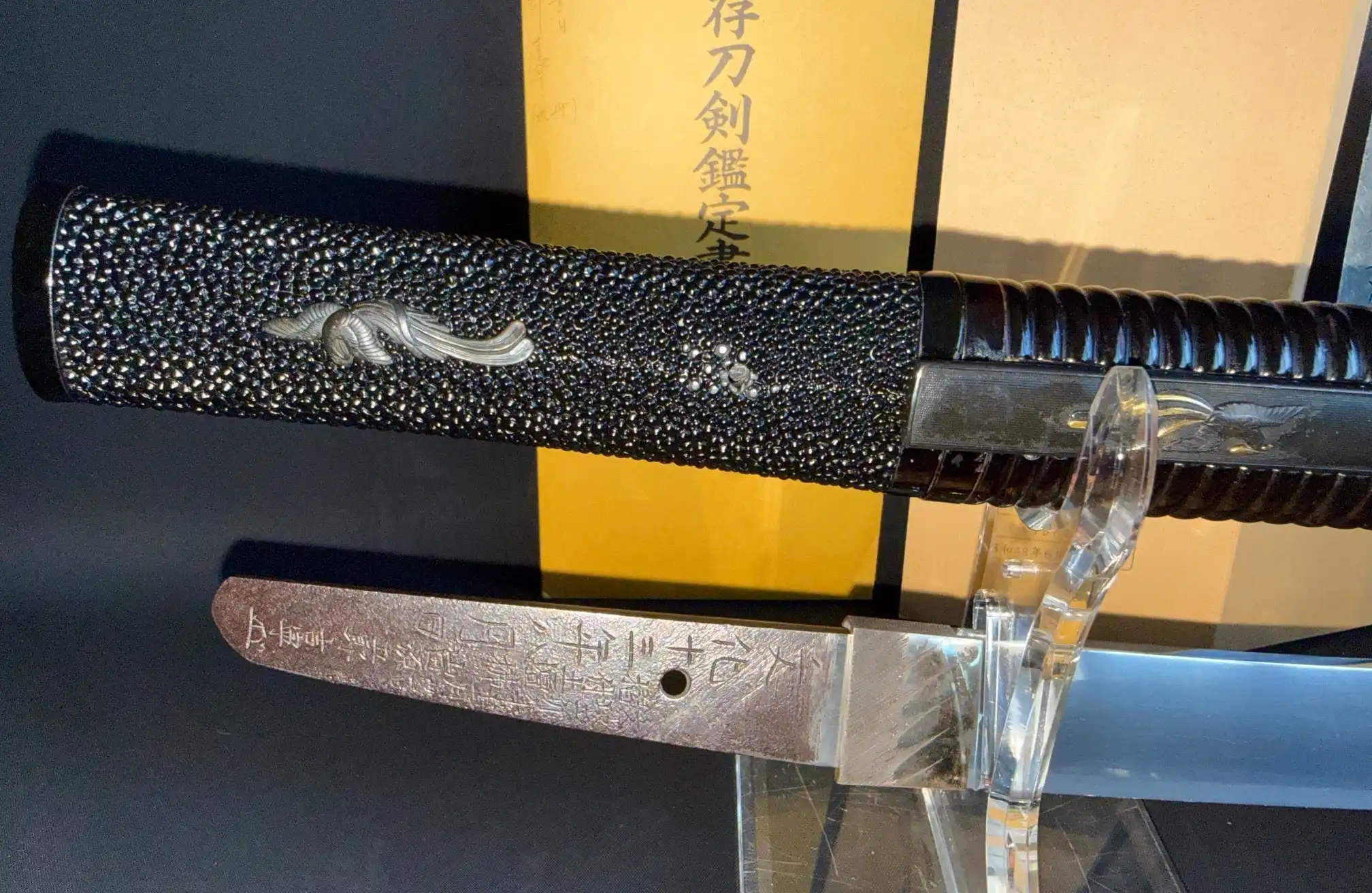 Close-up of Suishinshi Masahide Wakizashi handle and tang inscriptions, detailed view of samegawa and mei.