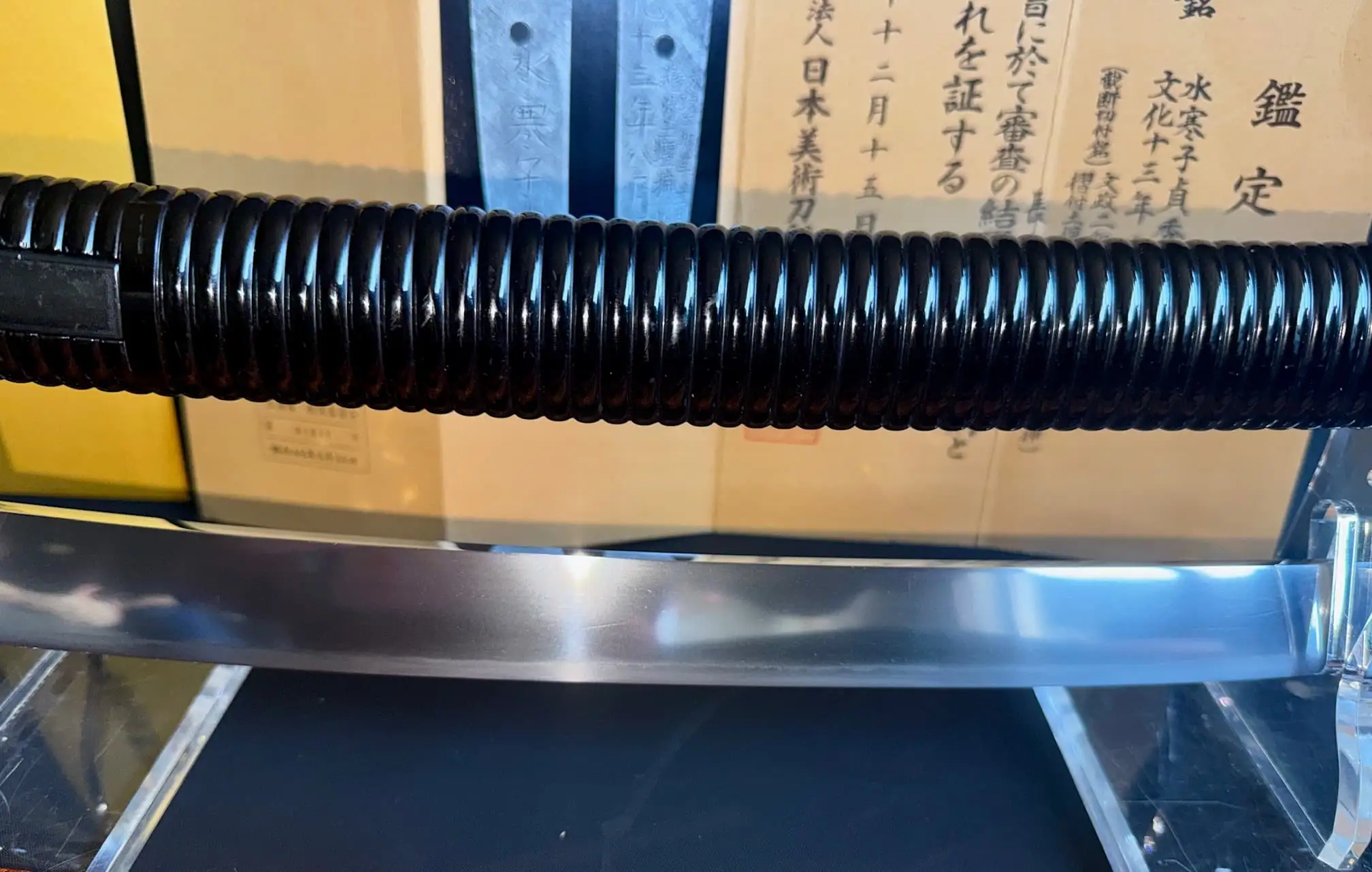 Suishinshi Masahide Wakizashi blade and scabbard, with Japanese text in background highlighting NBTHK certification