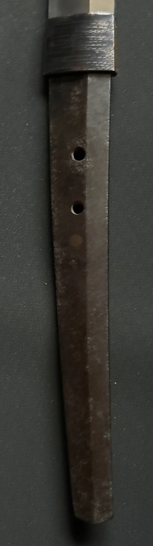 Close-up of the rusty tang (nakago) of an Aoe Nagamaki-Naoshi Katana with two mekugi-ana holes.
