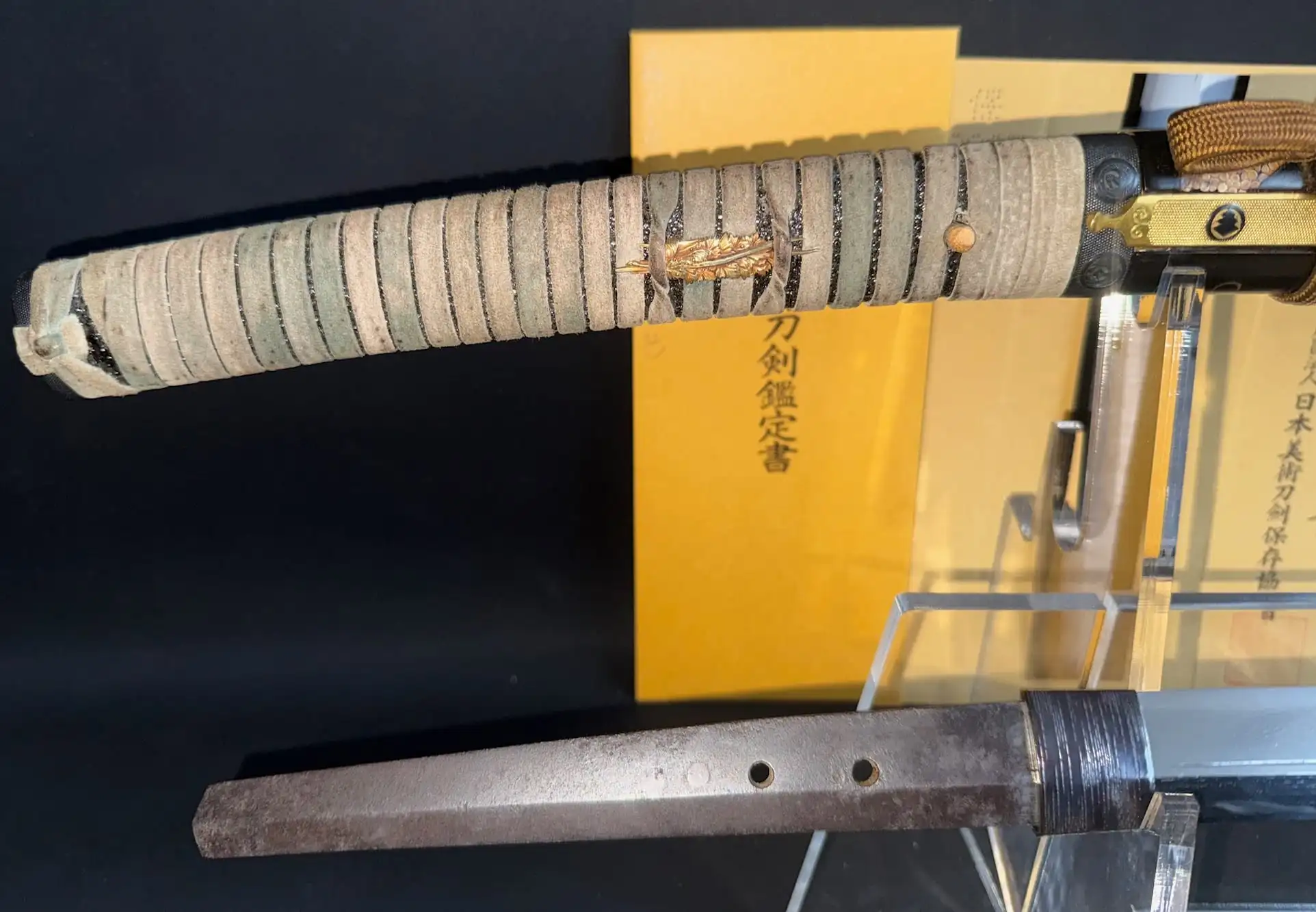 Close-up of a Kamakura Period Aoe Nagamaki-Naoshi Katana handle with golden menuki and rusted nakago