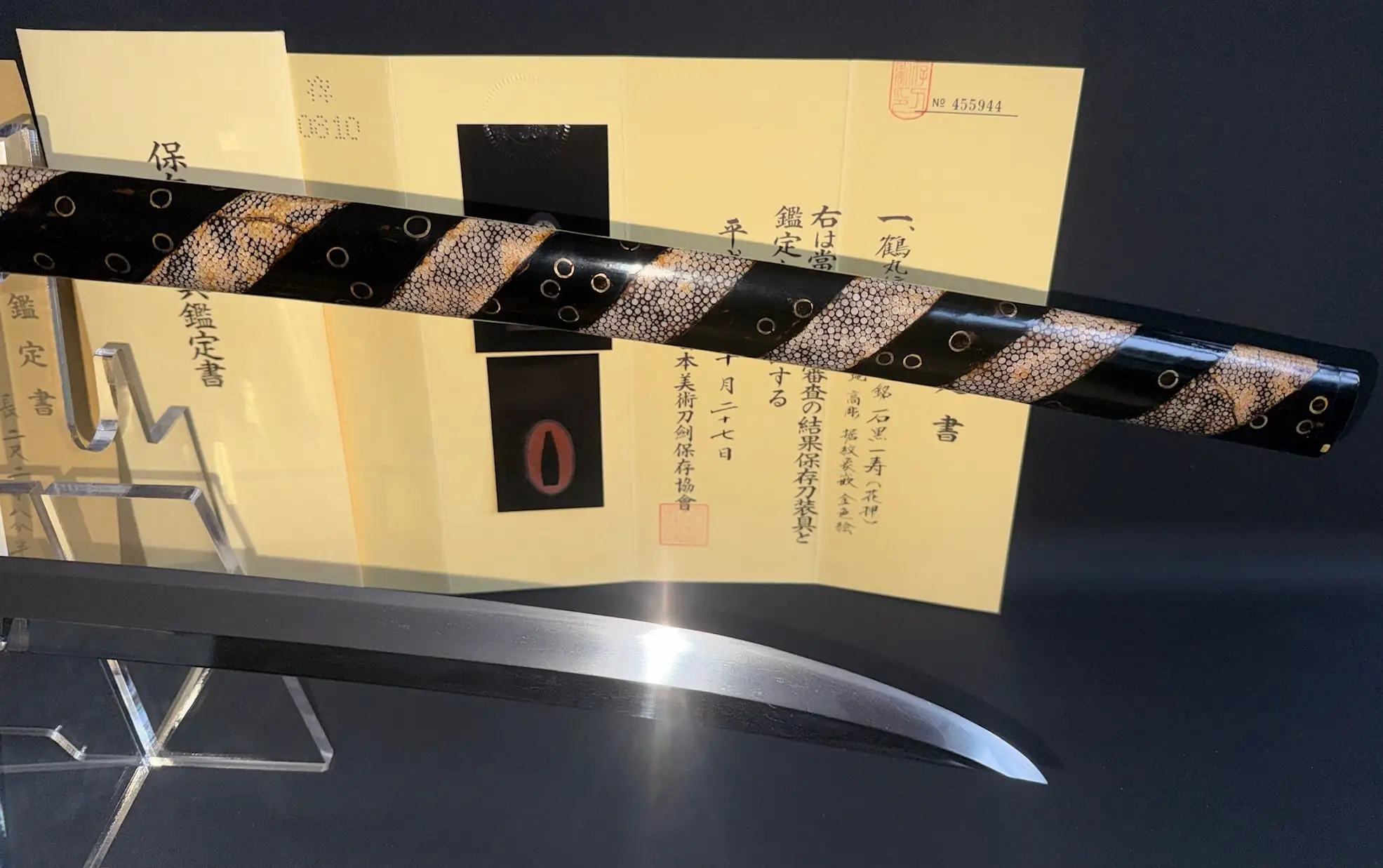 Close-up of Aoe Nagamaki-Naoshi katana sword handle and blade with certificate in background