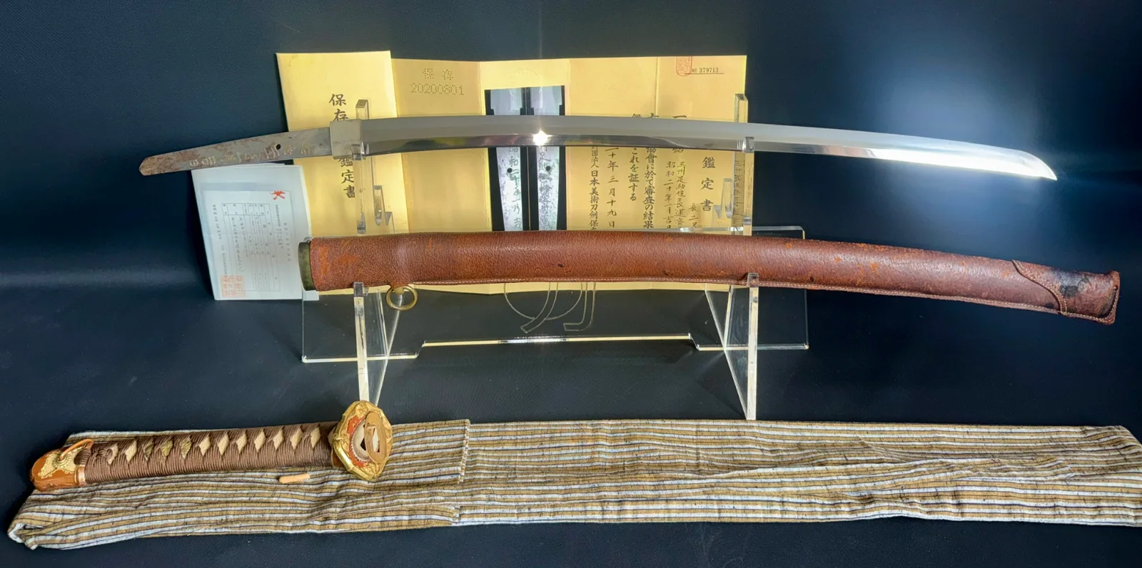 Chōunsai Shigemitsu Katana 1945 Japanese sword, full view, with certificate, saya, and tsuka partially visible