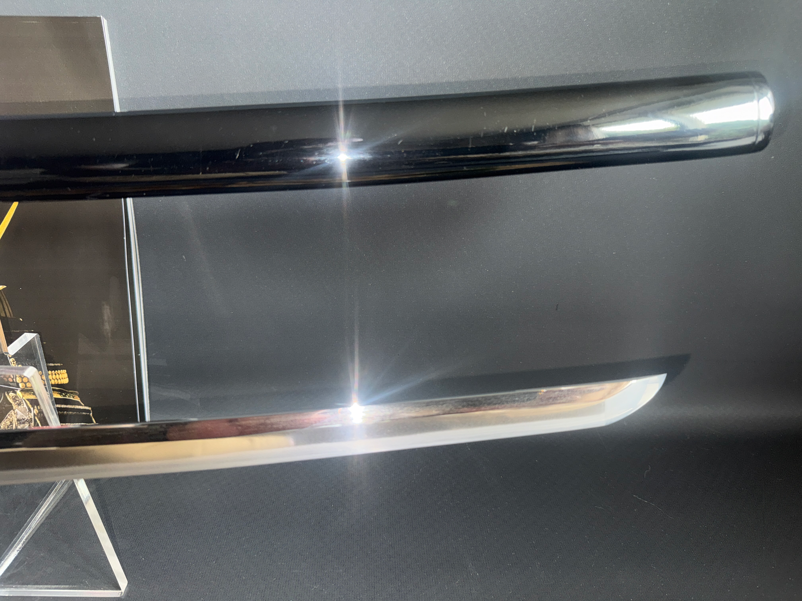 Close-up of a Katana Gendaitō Battleship Mikasa blade and black Saya, showing a sharp kissaki