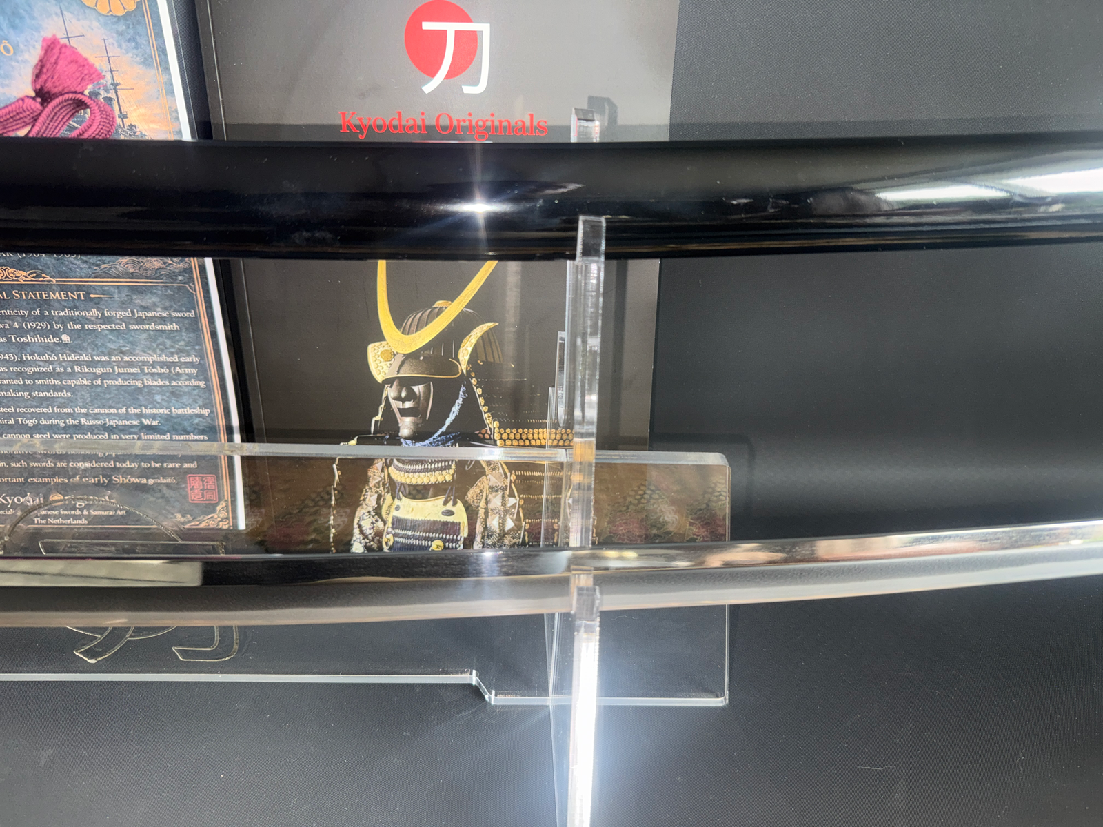 Polished Gendaitō Battleship Mikasa katana blade on a stand, showcasing its hamon, with Kyodai Originals logo