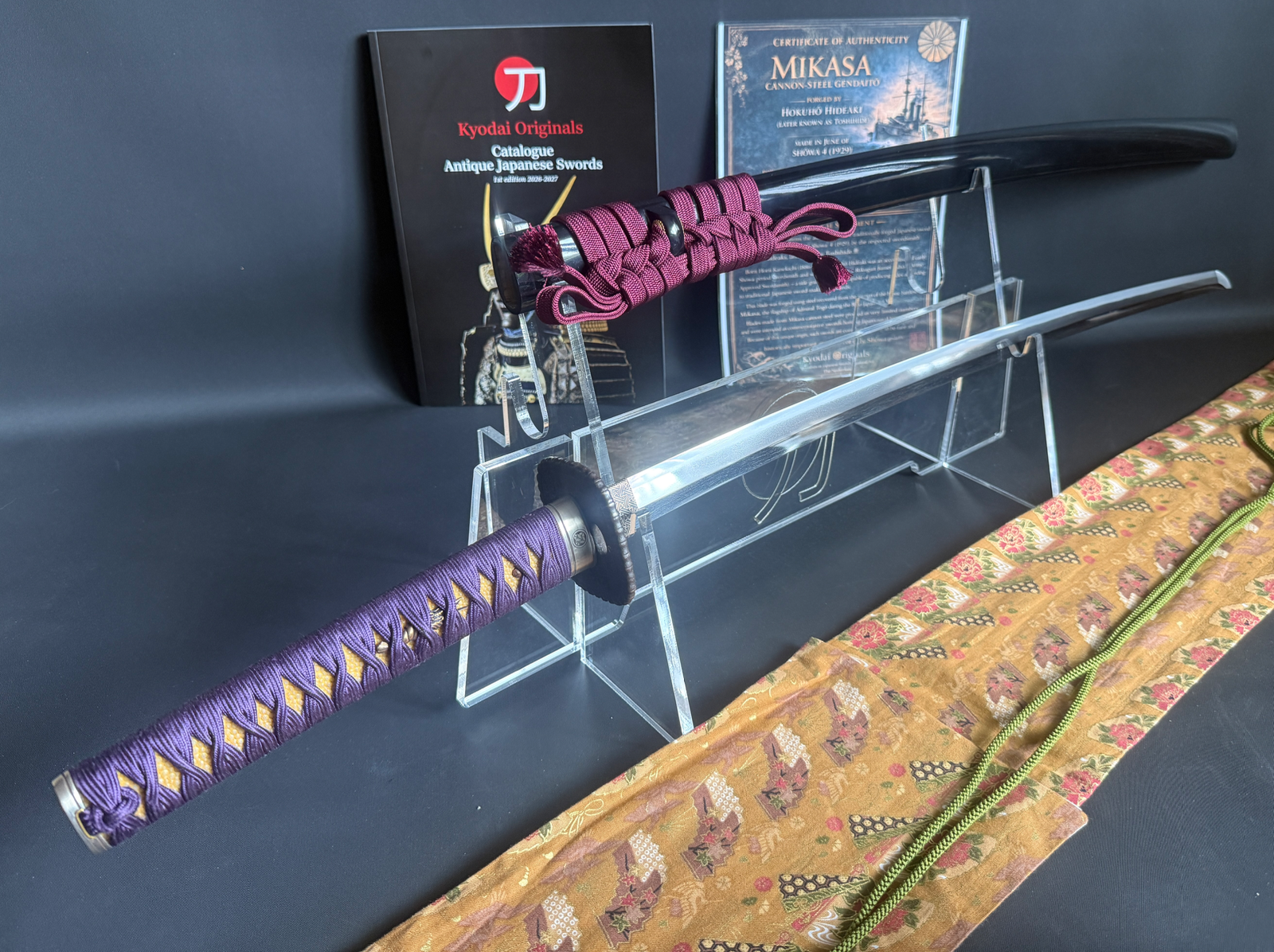 Gendaitō Battleship Mikasa Katana with purple tsuka and black saya on a display stand, with certificate and catalogue