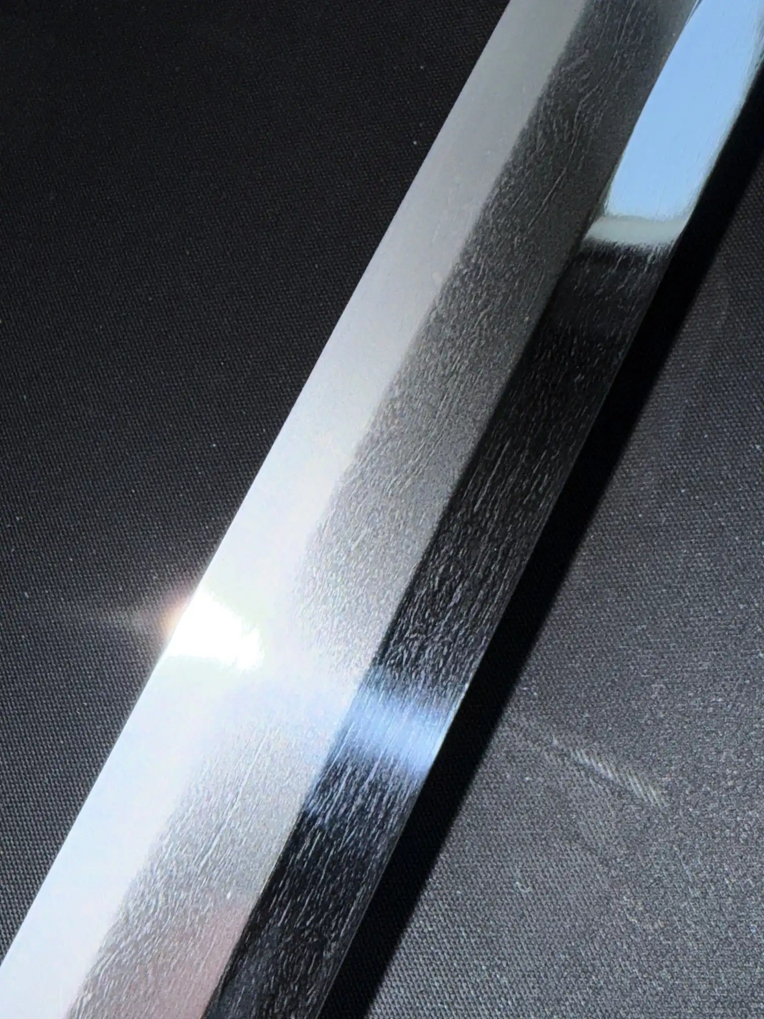 Close-up of a Gendaito Battleship Mikasa katana blade showing hamon details and reflective surface