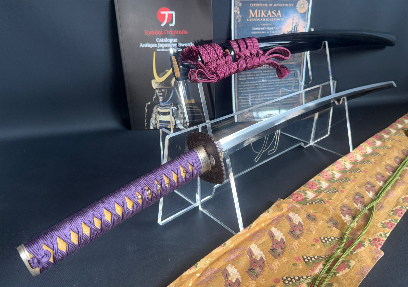Gendaitō Battleship Mikasa katana, angled view of blade, purple tsuka-ito, and black saya with burgundy sageo.