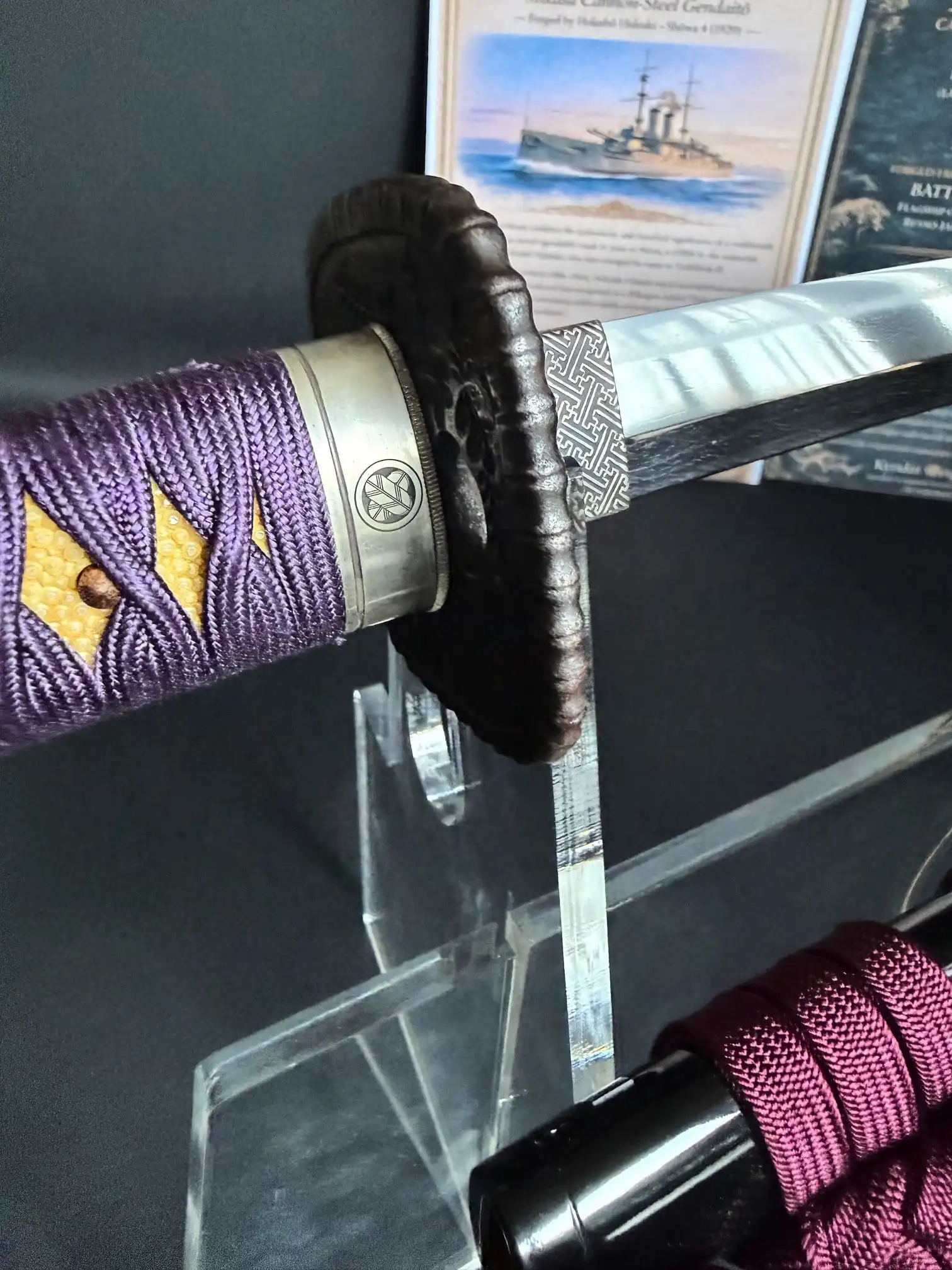 Gendaitō Battleship Mikasa katana close-up, showing purple tsuka ito, detailed tsuba, and polished blade.