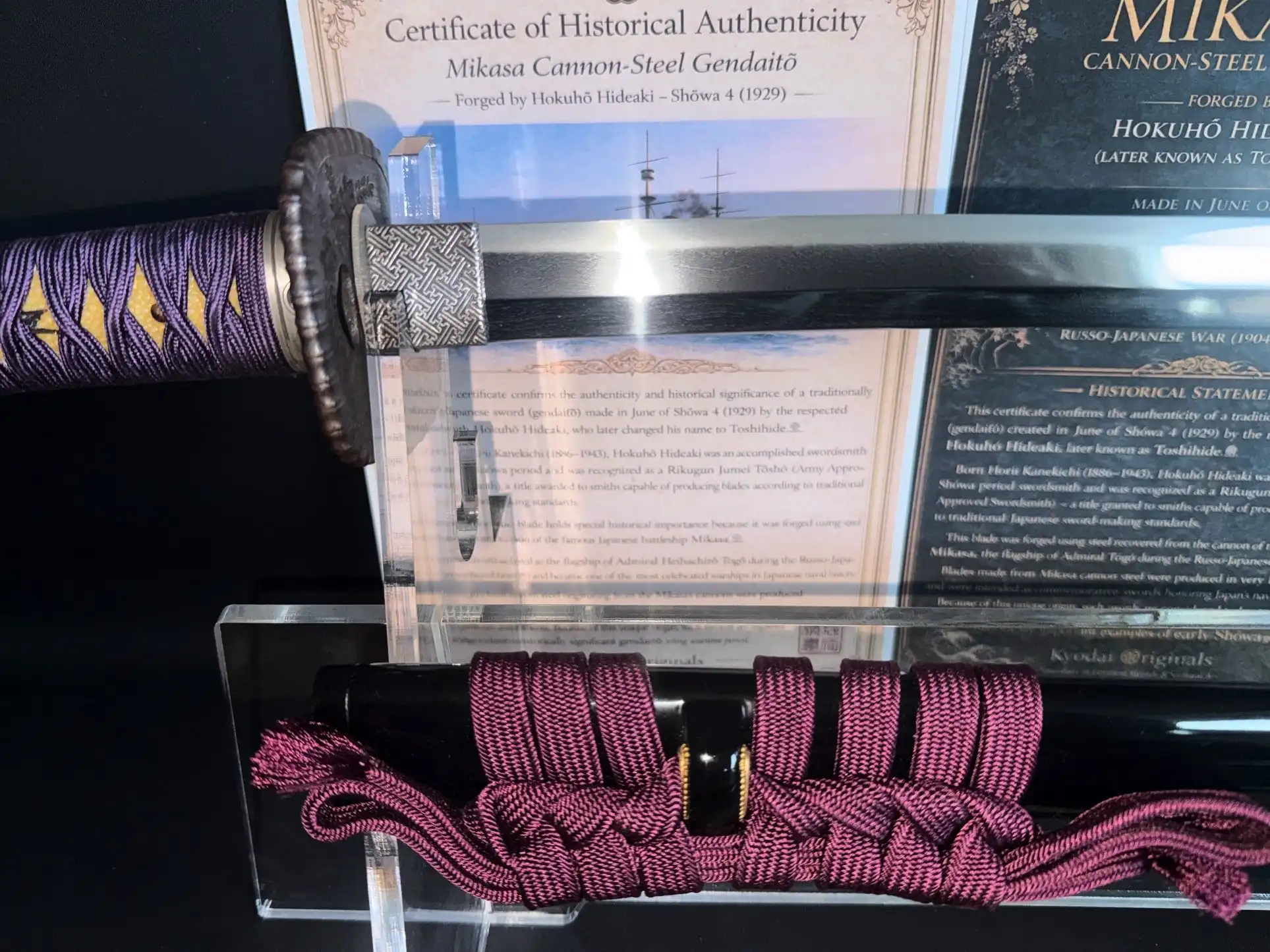 Gendaitō Battleship Mikasa Katana with purple tsuka-ito, tsuba, and certificate of authenticity displayed.