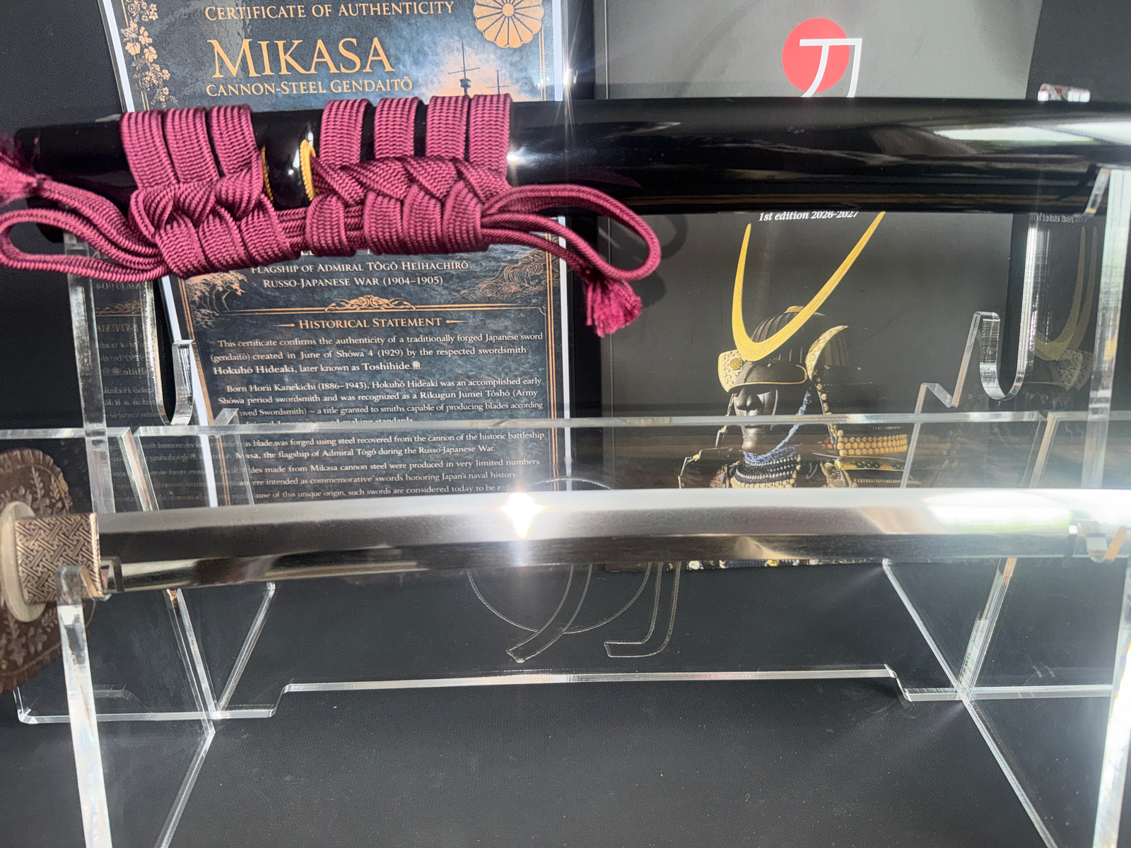 Close-up of a Gendaitō Battleship Mikasa Katana with a dark red tsukamaki and polished blade.